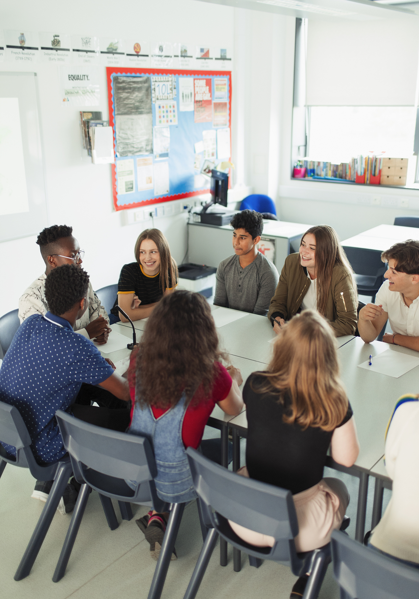 high school students talking during debate class in classroom