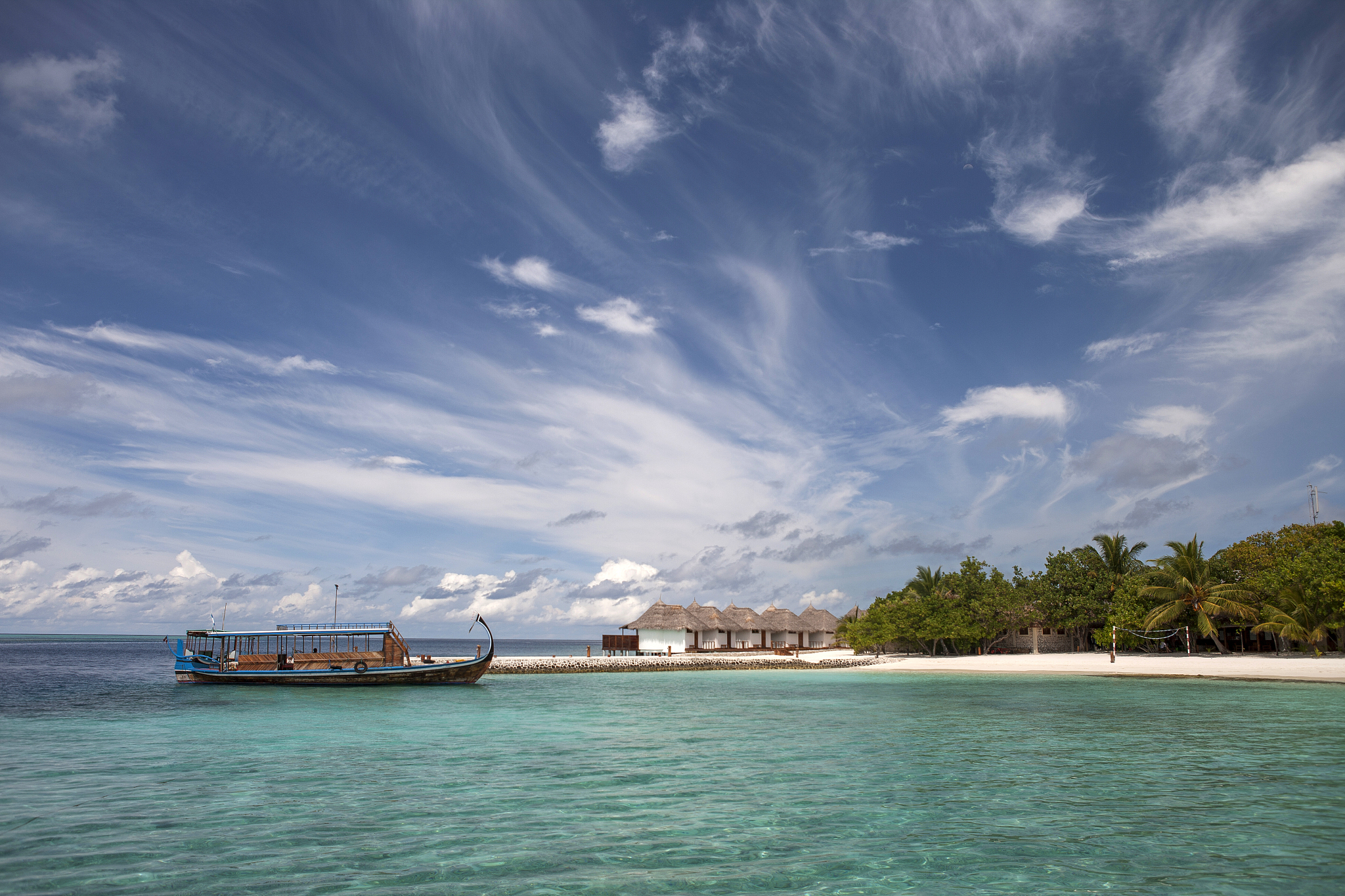 maldives. traditional boat in a tropical island.