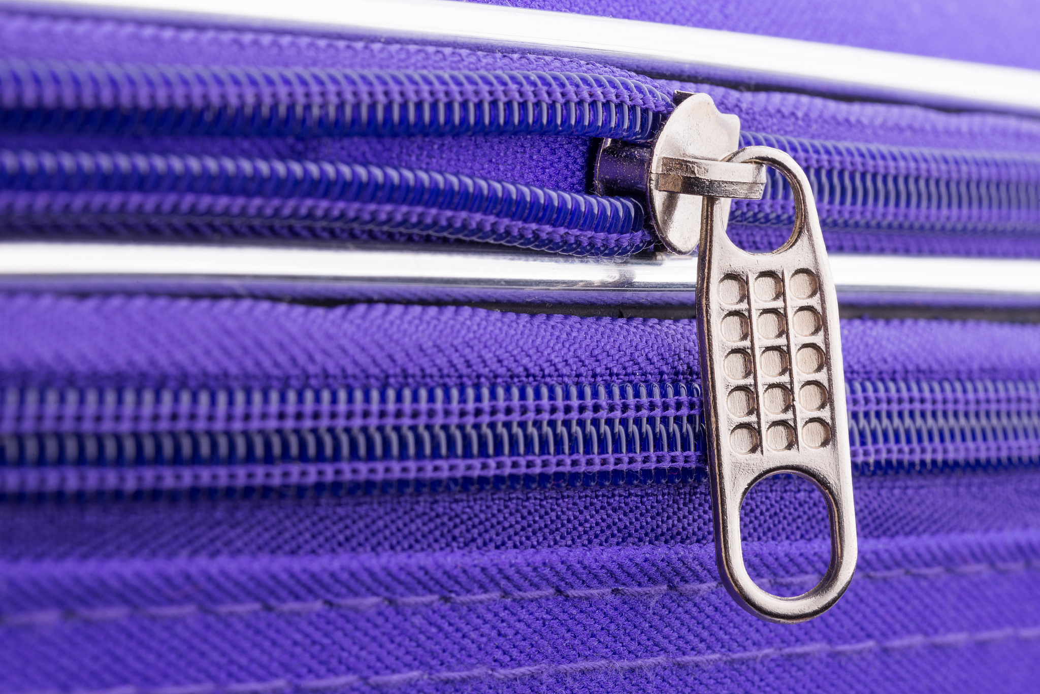 pull tab and chain of a zipper on a suitcase