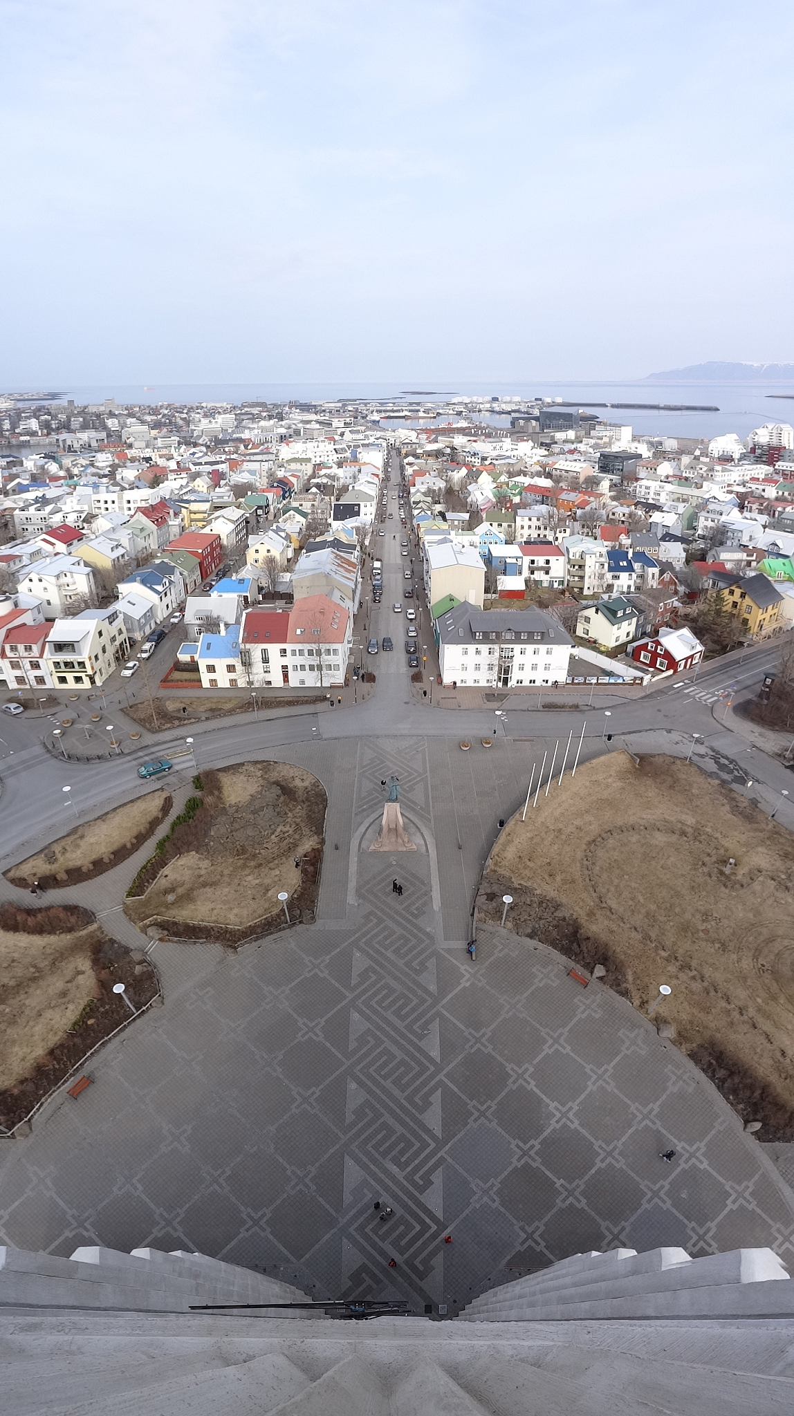 aerial view of city by sea against sky