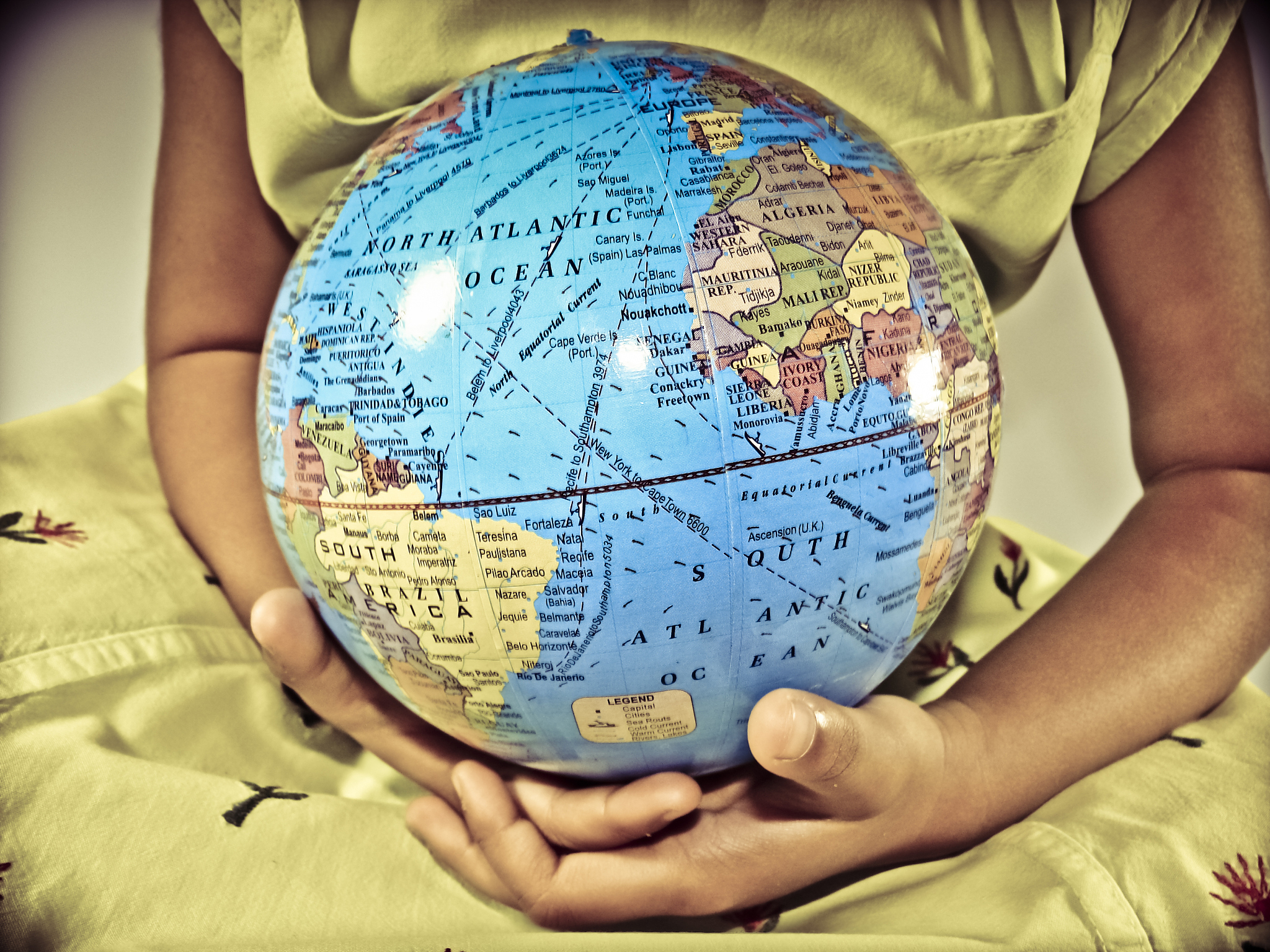 small girl with model of planet earth