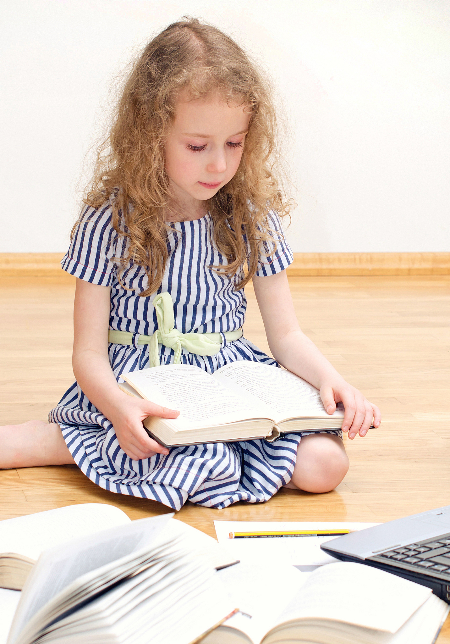 smart little girl writes diploma at home.