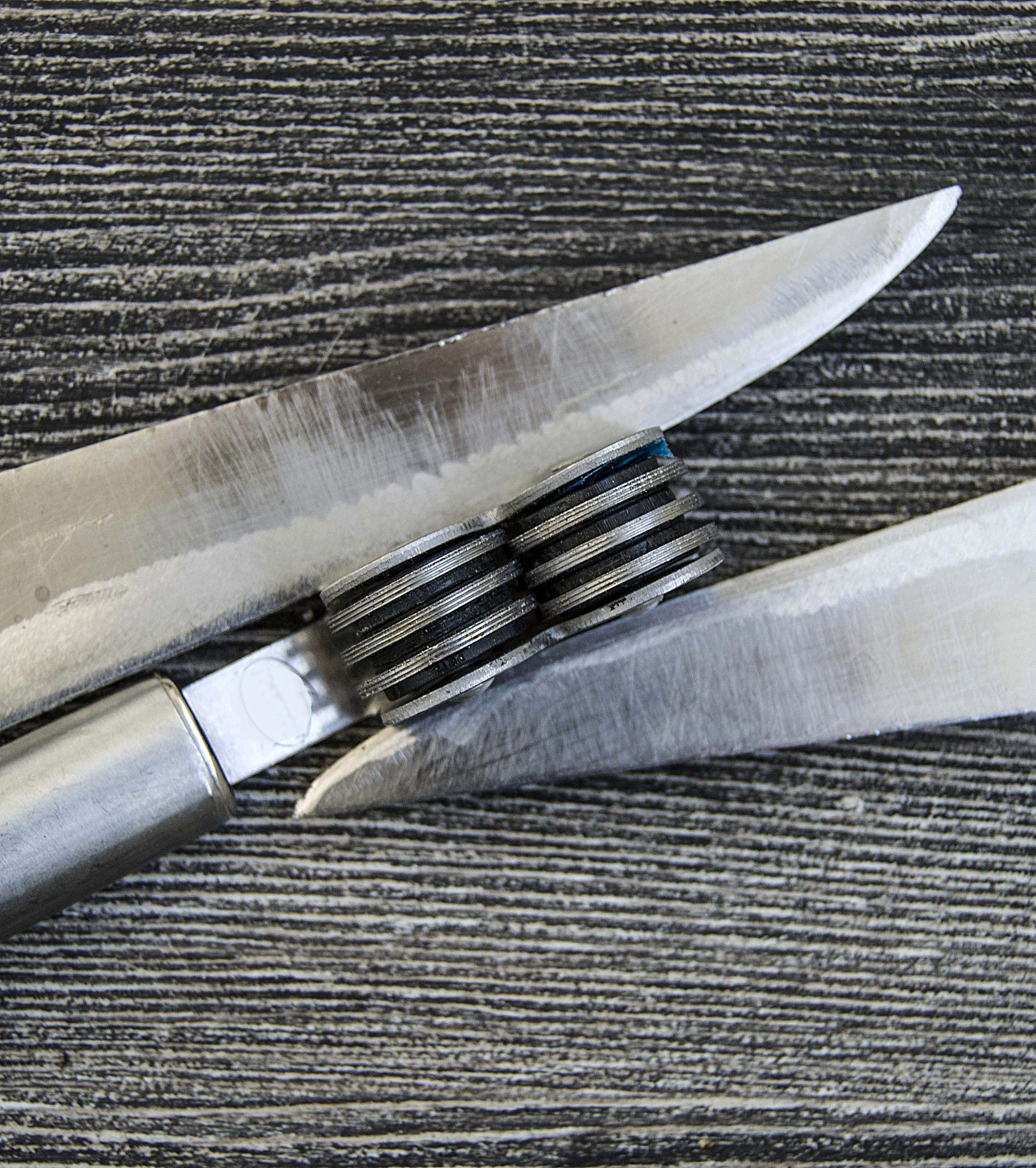 knives stands next to the blade grinding tools, knife sharpening