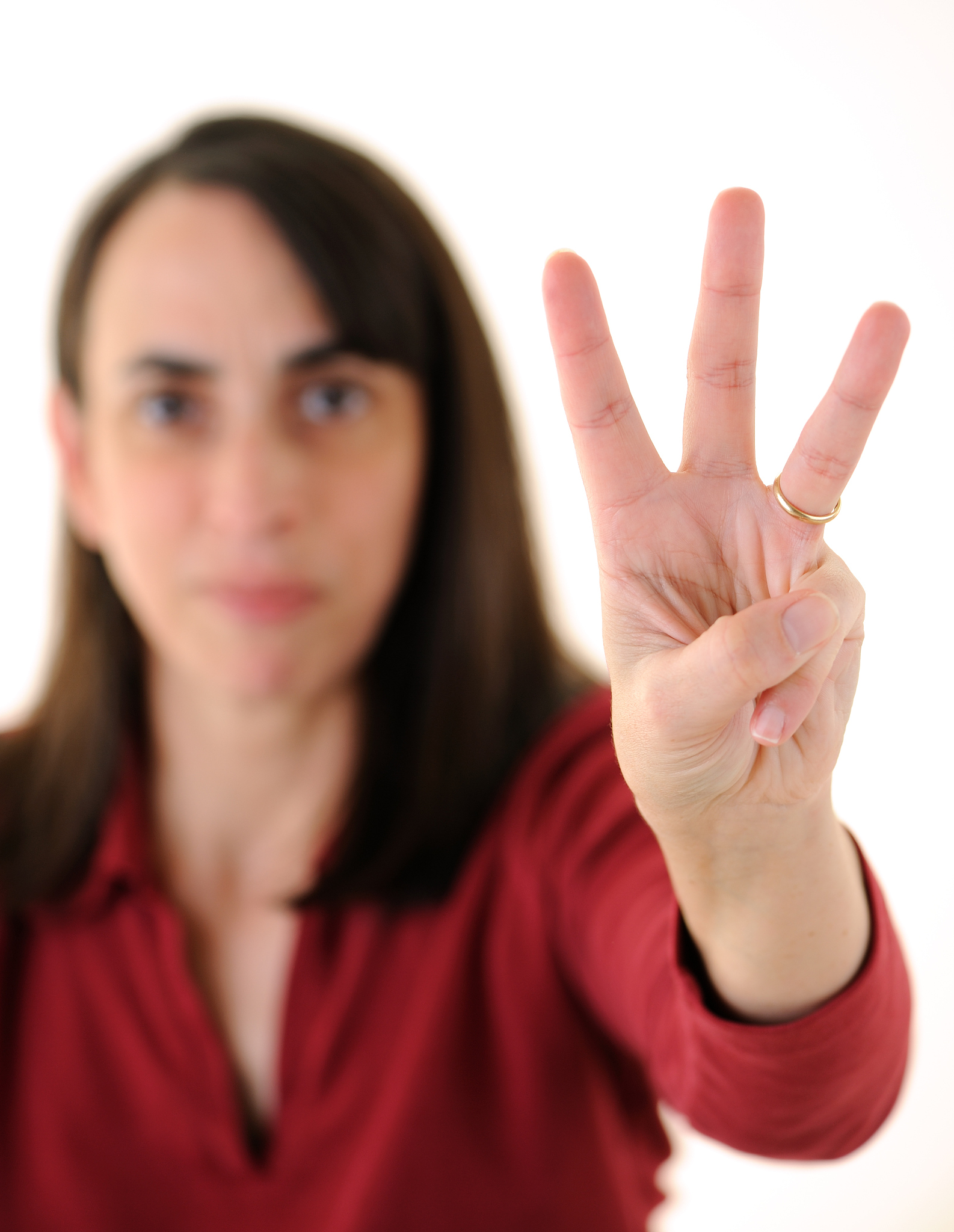 woman holding up three fingers