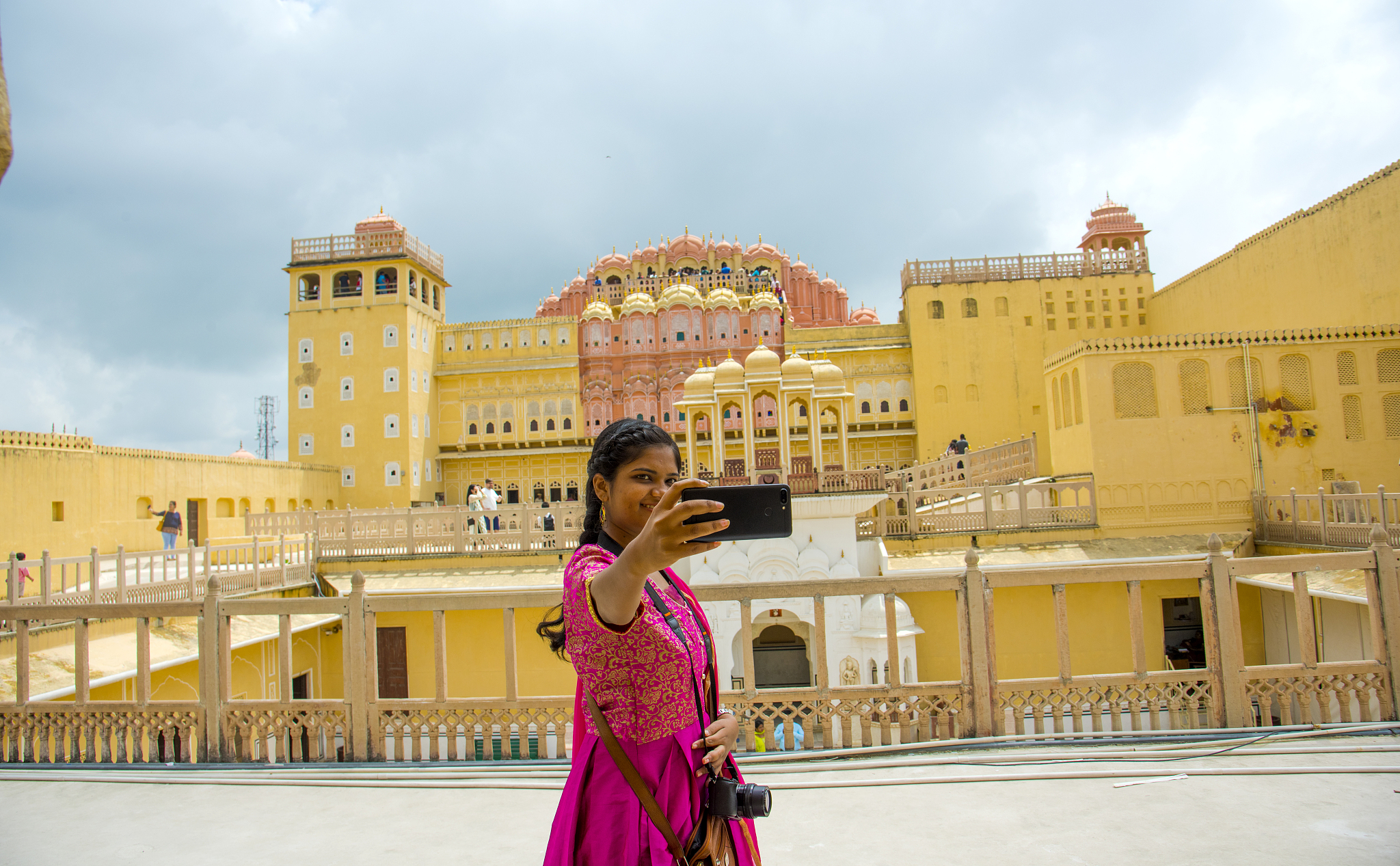woman taking photos in front of hawa mahal, jaipur, rajasthan, i