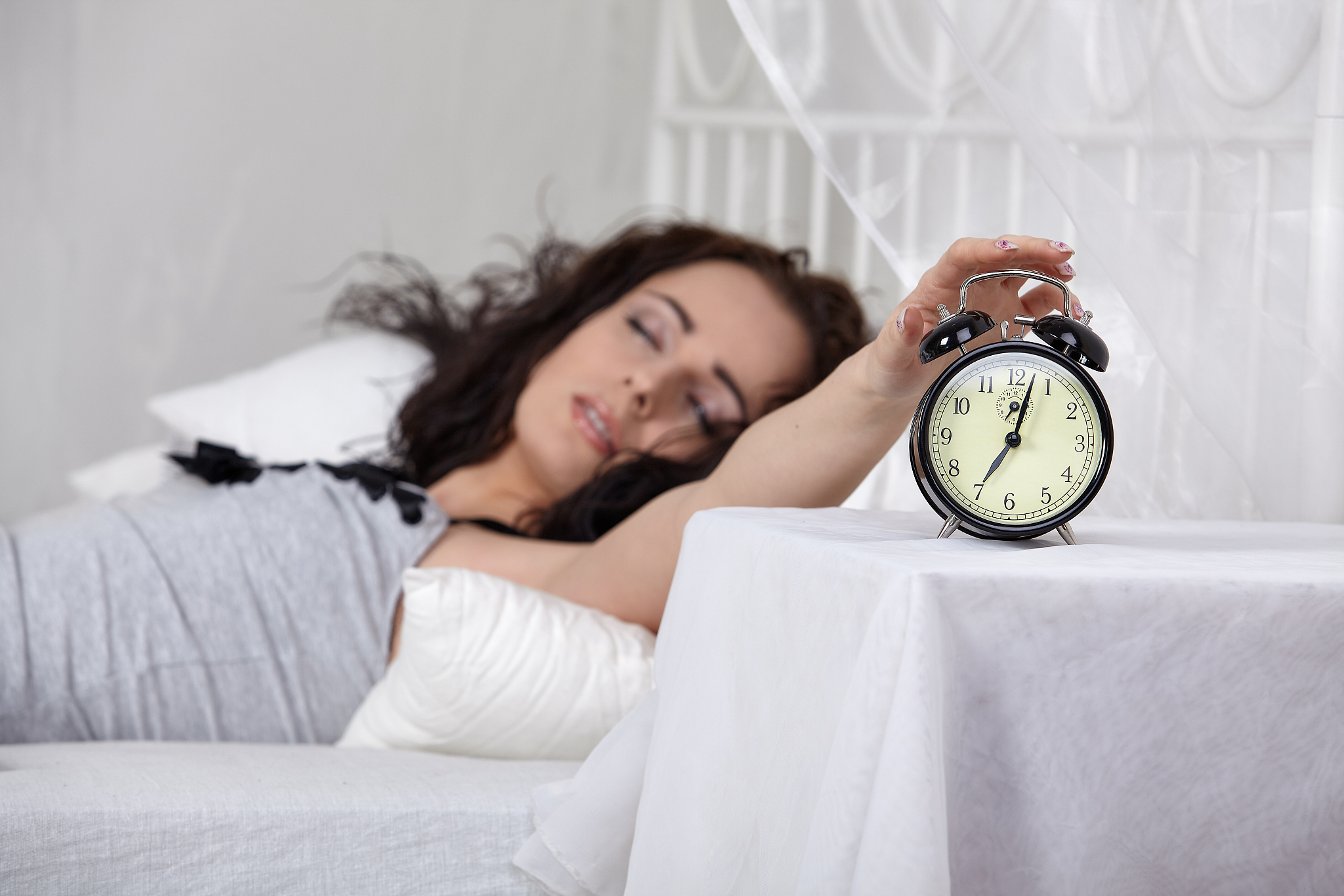 young woman sleeps in bed at home.