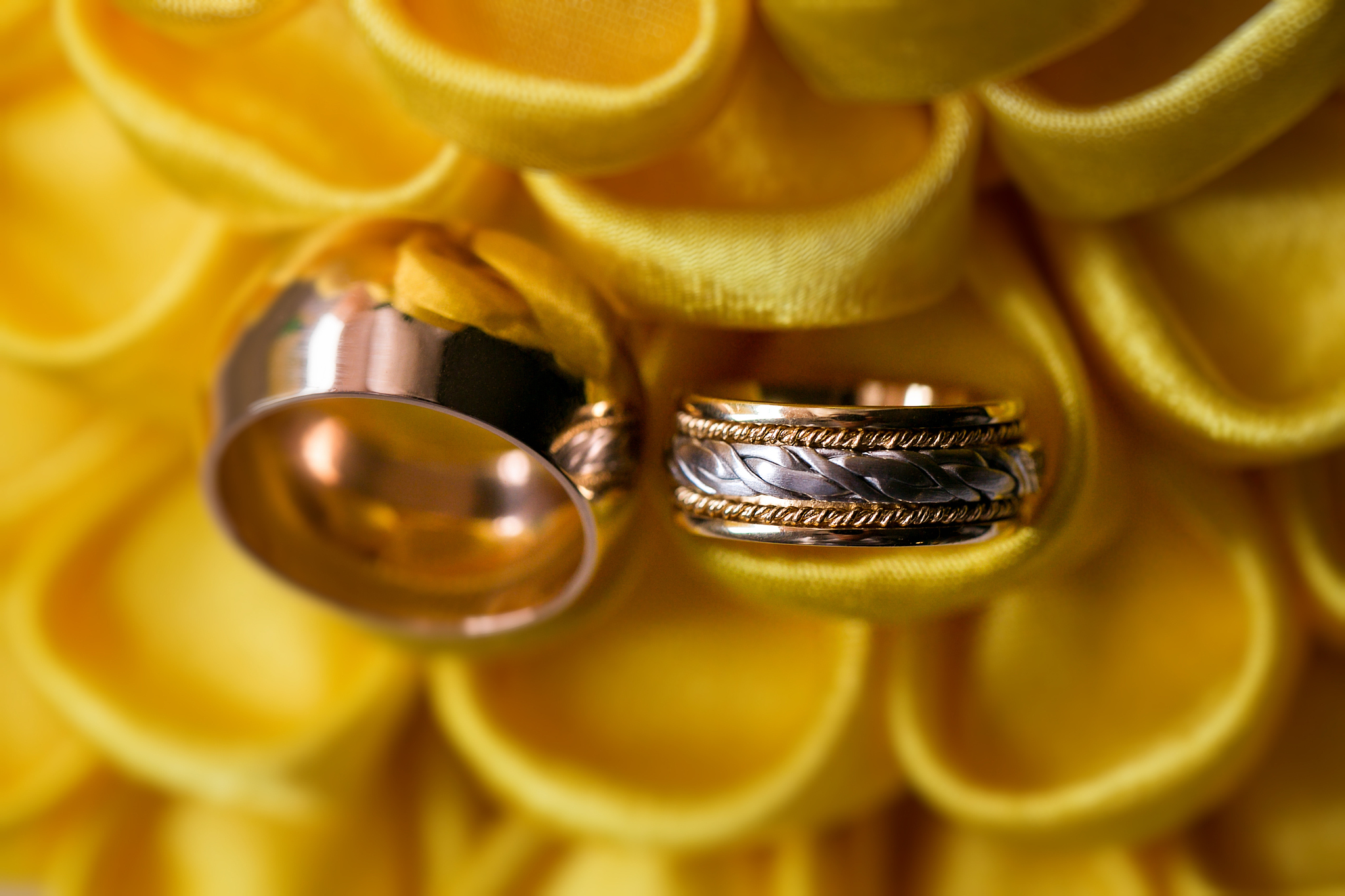 diamond ring on yellow flower. wedding rings together. selective