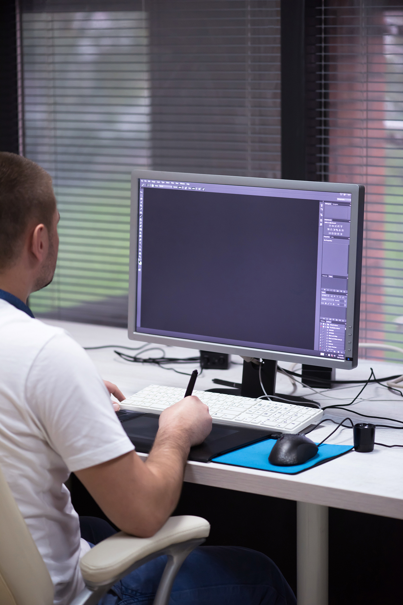 creative worker, photo editor working on graphic tablet at his d