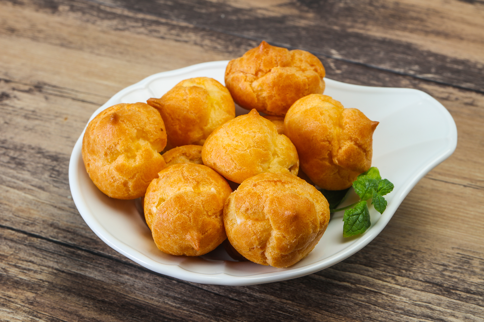 sweet tasty profiteroles heap in the bowl