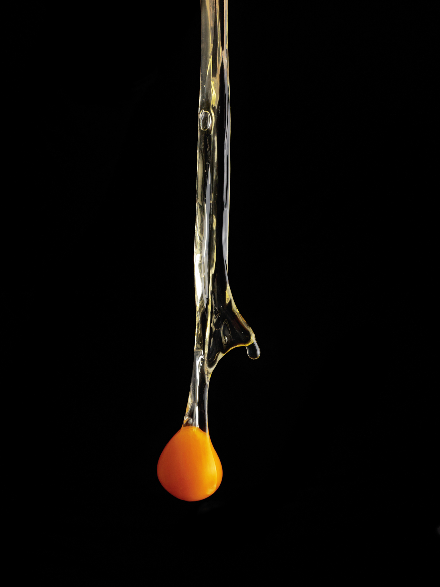 hands breaking an egg.