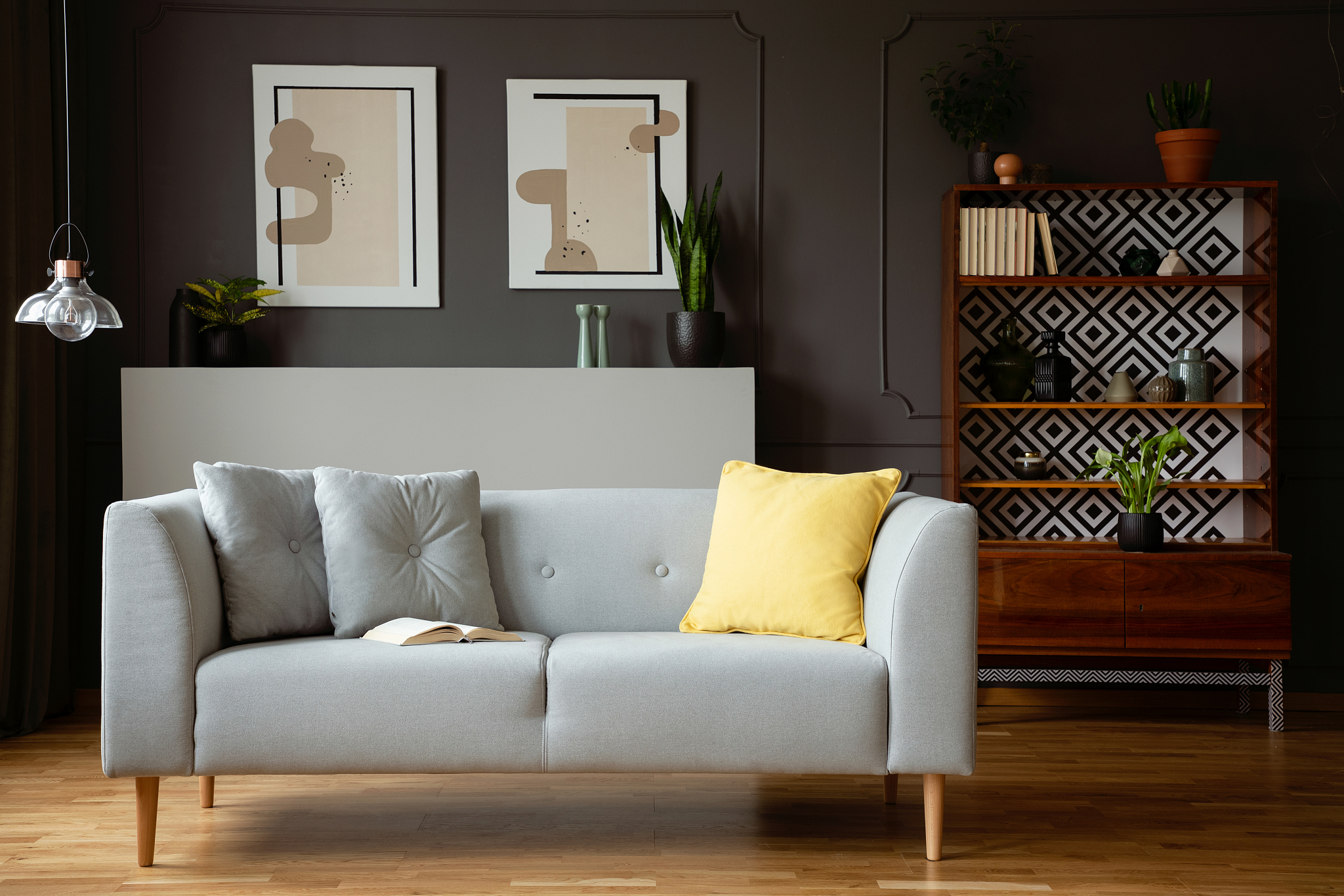 yellow pillow on grey couch in vintage living room interior with