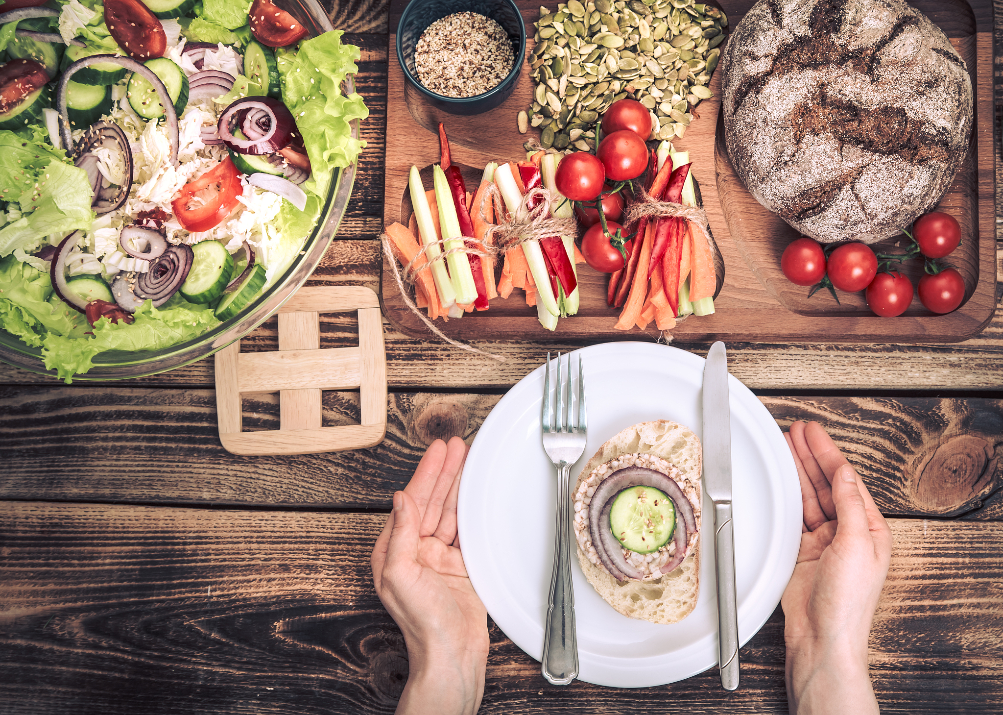 lunch at the table with different food, women's hands with a pla