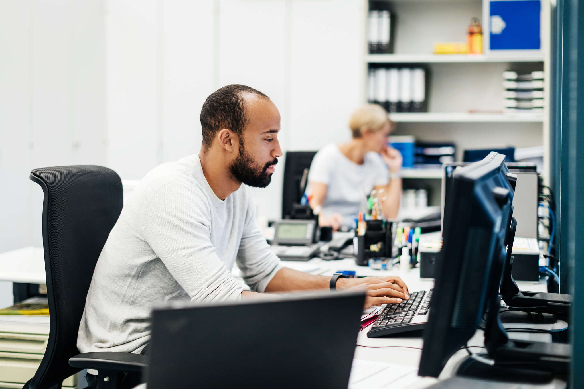 senior engineer working on computer in office
