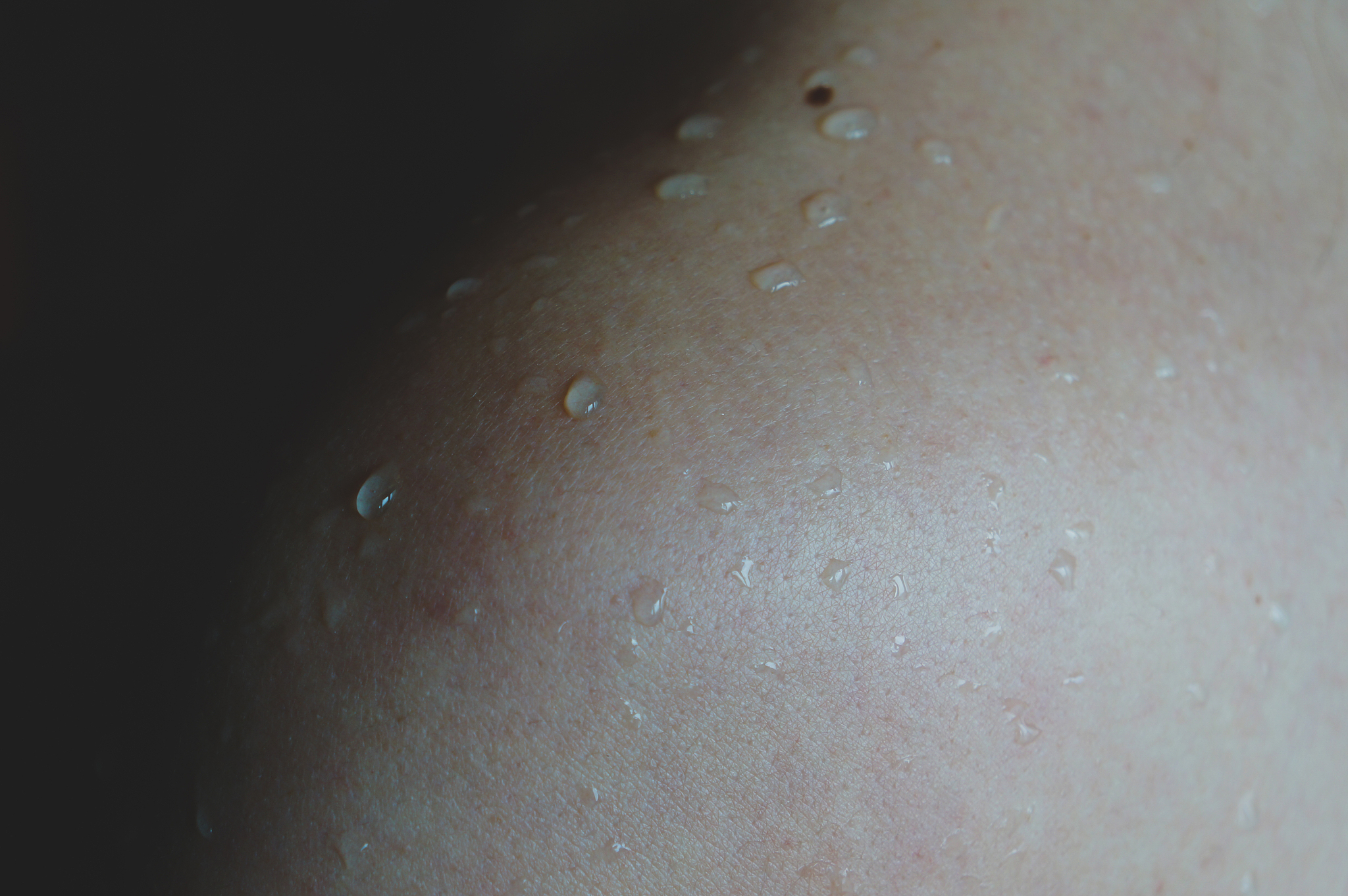 female shoulder with water drops