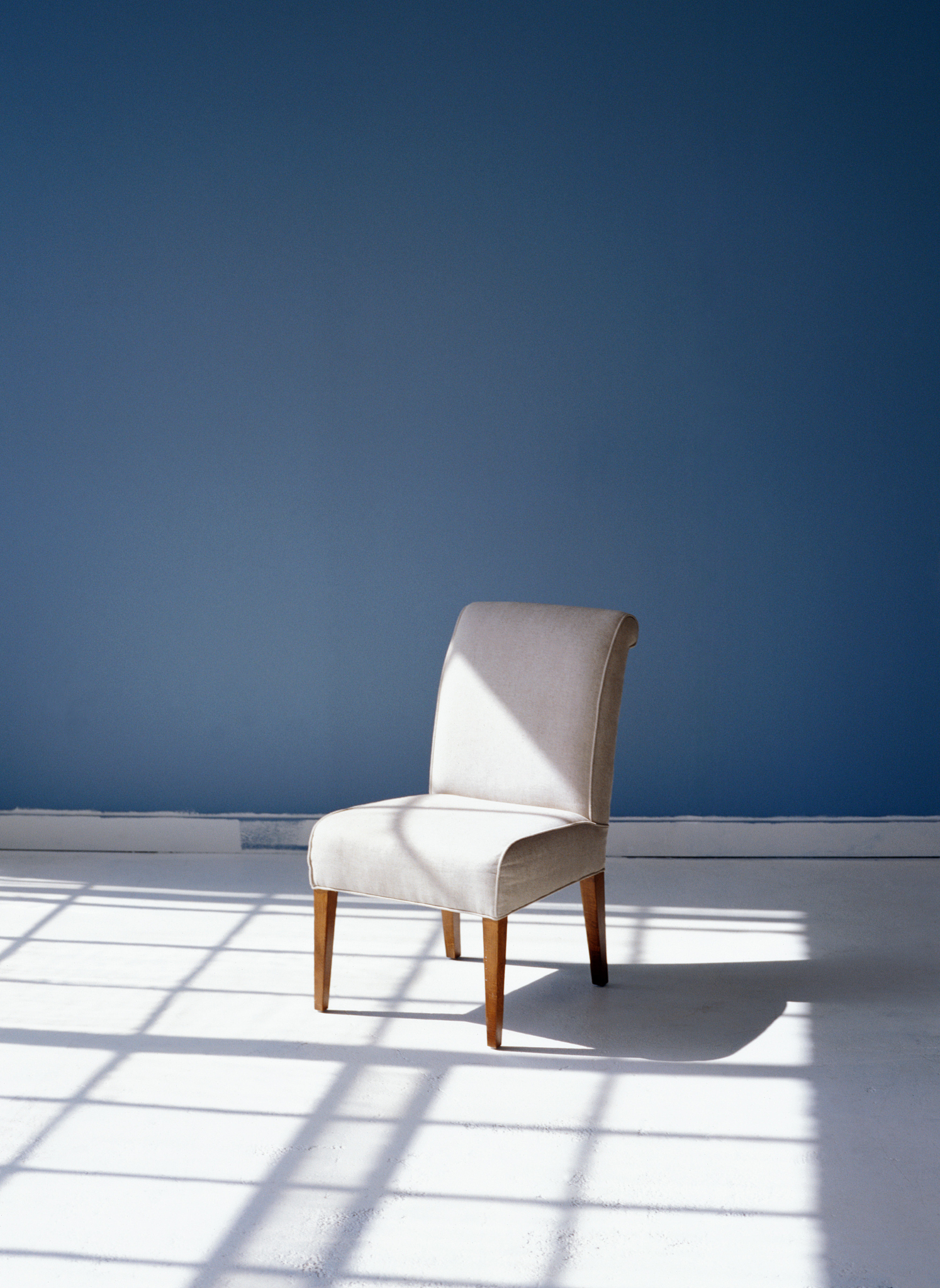 white chair in a room with blue walls