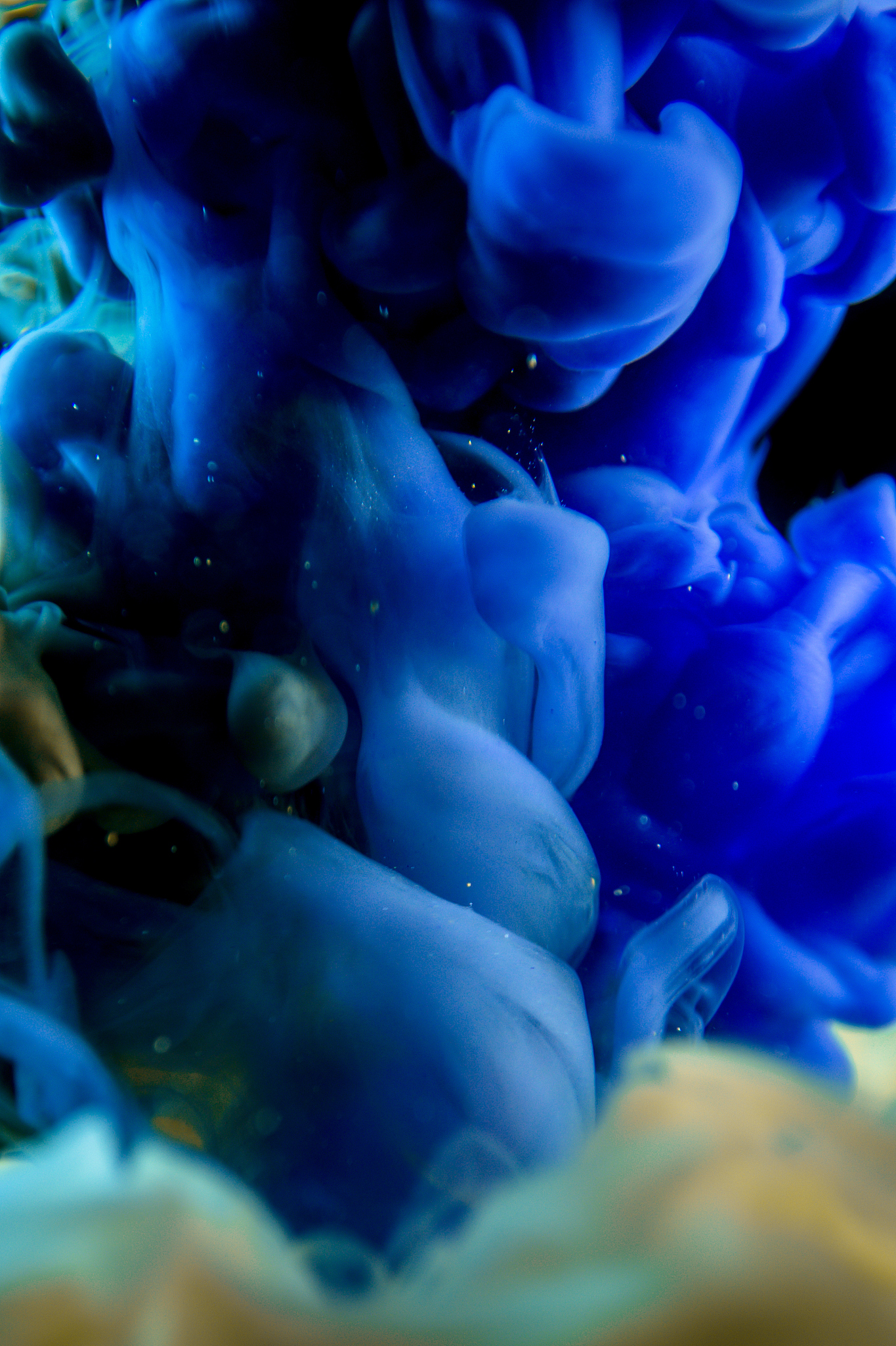 blue ink in water isolated on black background