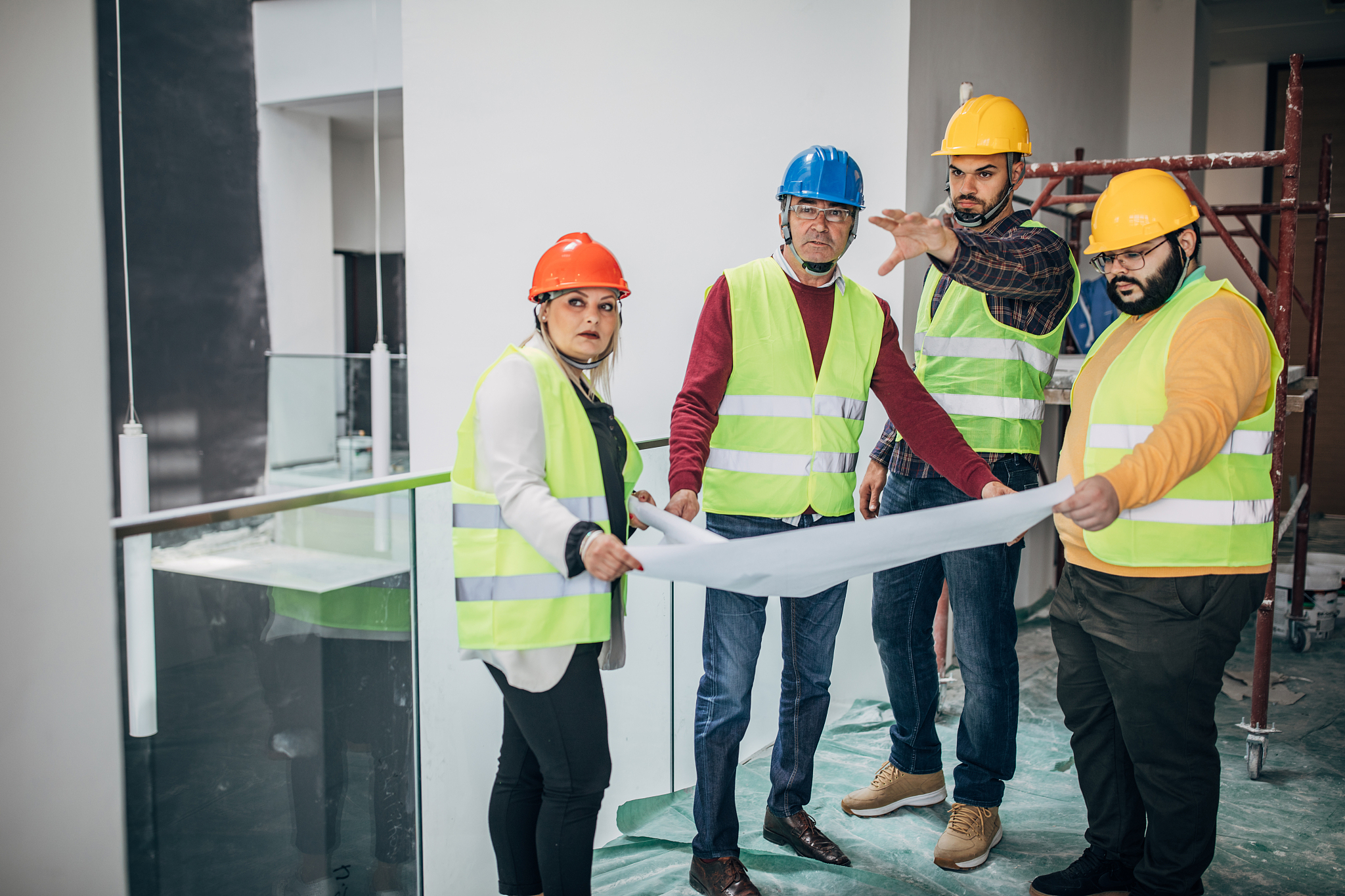 group of architects and engineers looking at building blueprint