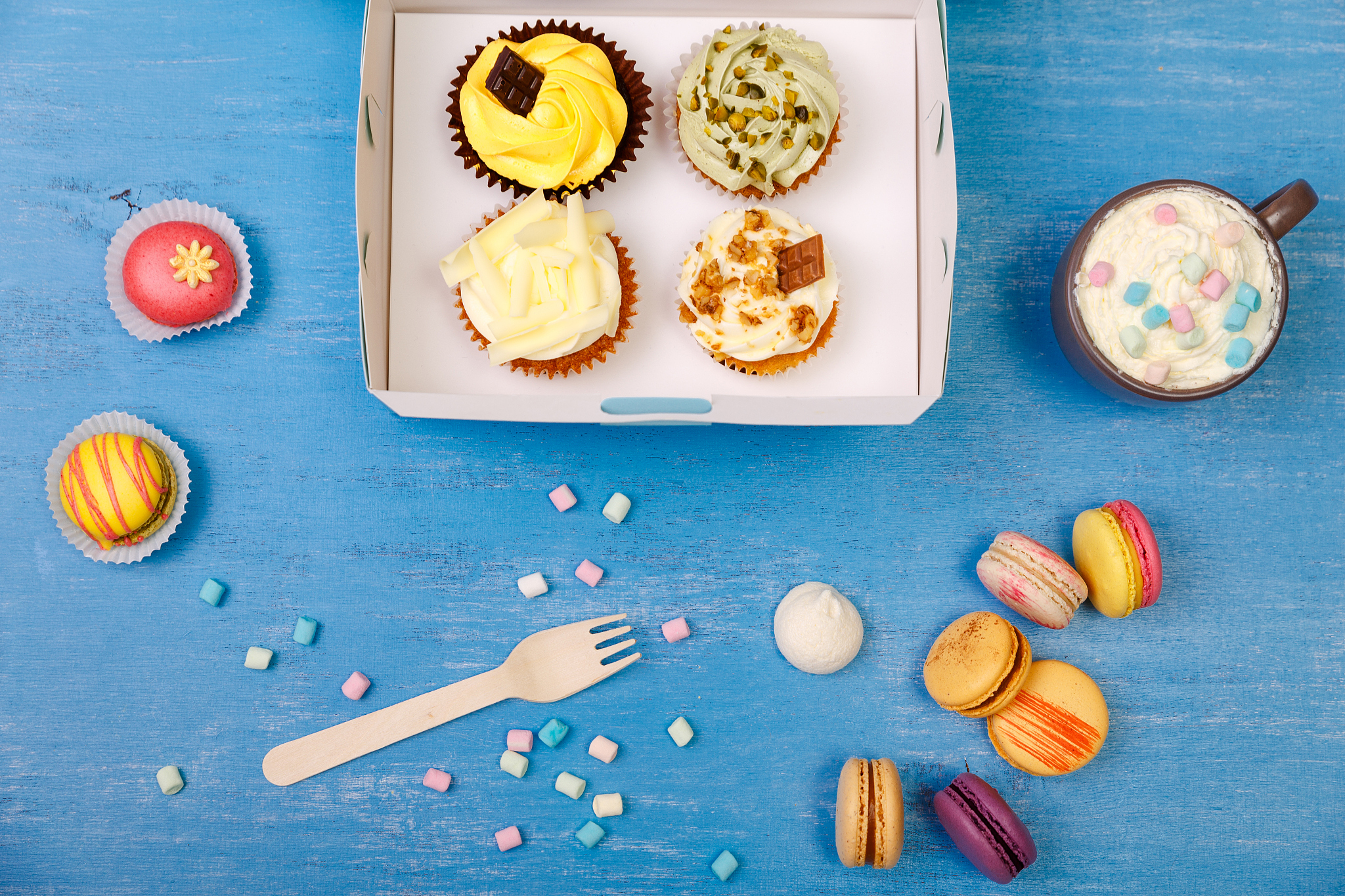 cupcakes and macaroons. sweet dessert in box.