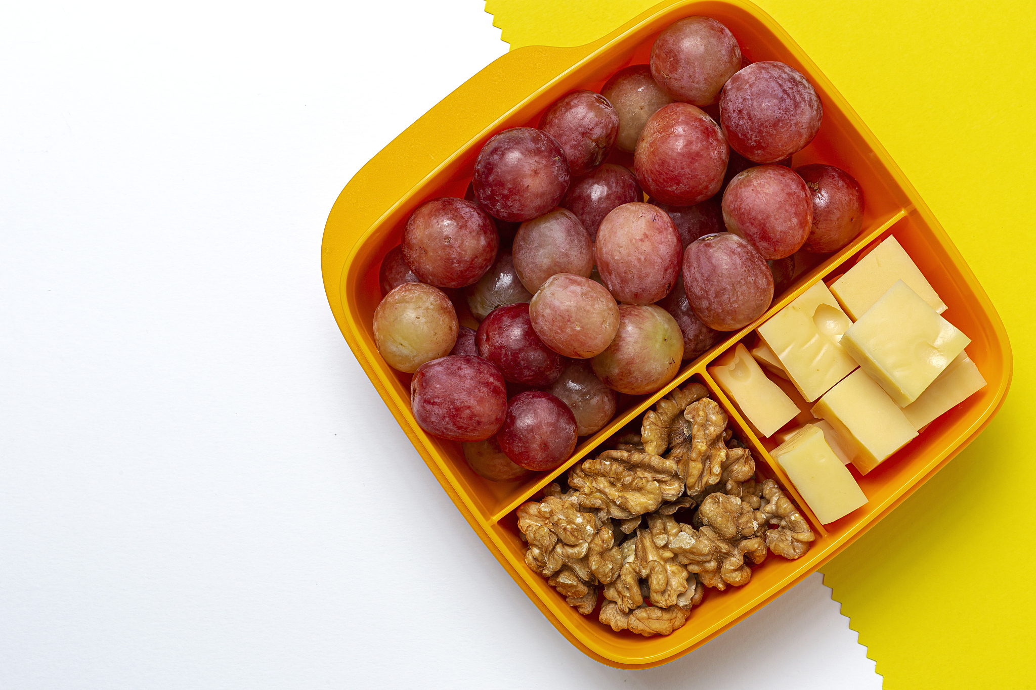 food in plastic containers ready to eat with cheese, grapes and 