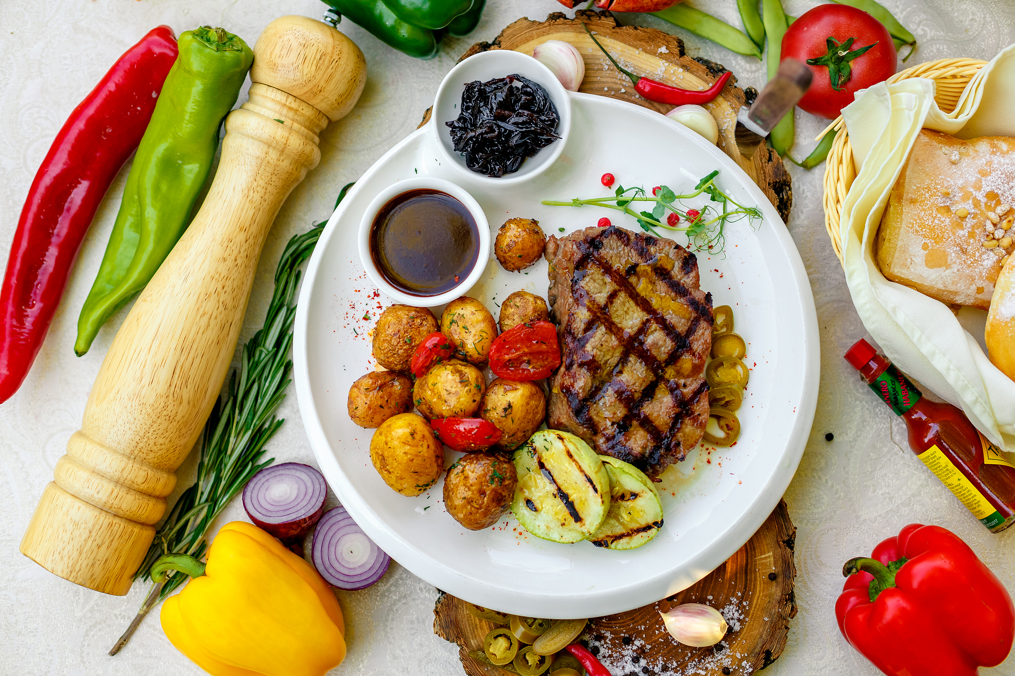 bbq, juicy steak with grilled vegetables and sauce on a white pl