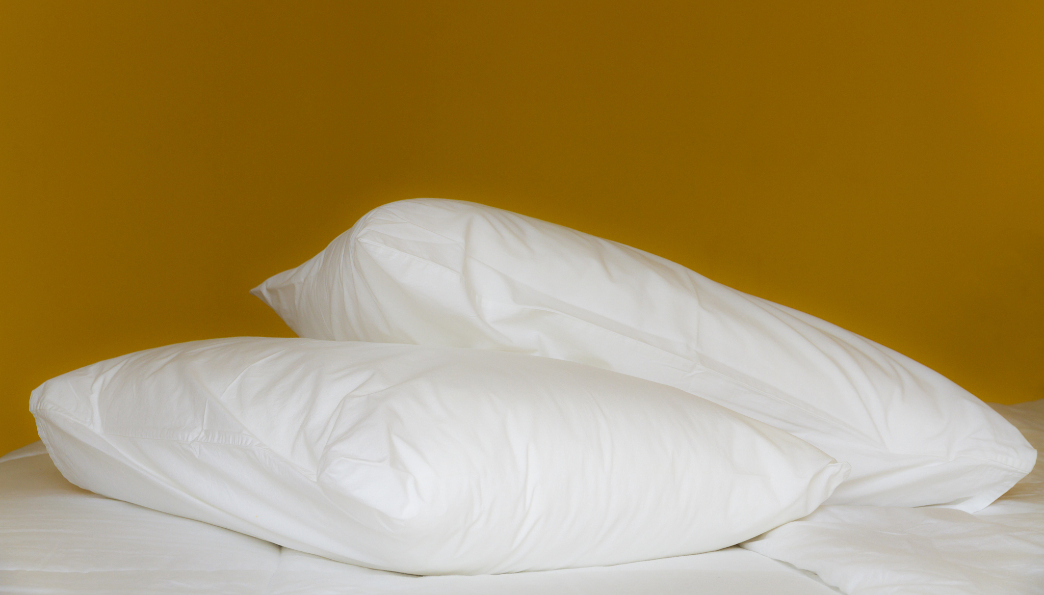 close up of a white pillows.