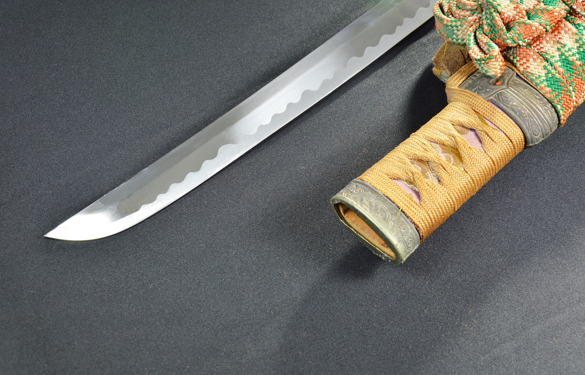 japanese samurai sword blade and scabbard on black fabric