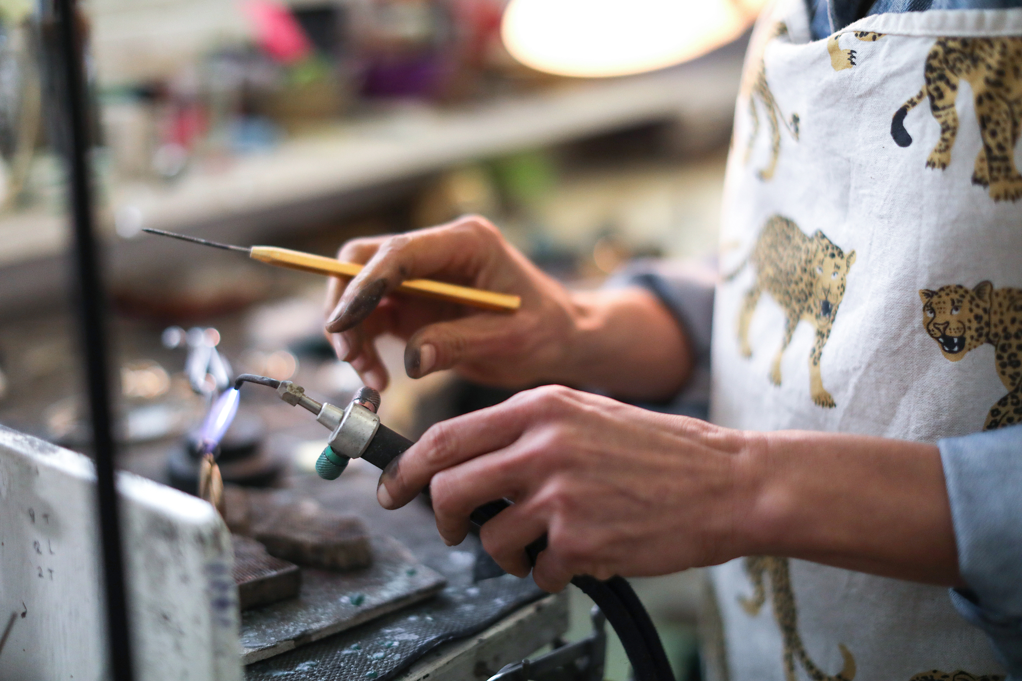 a jewellery designer working in her studio.