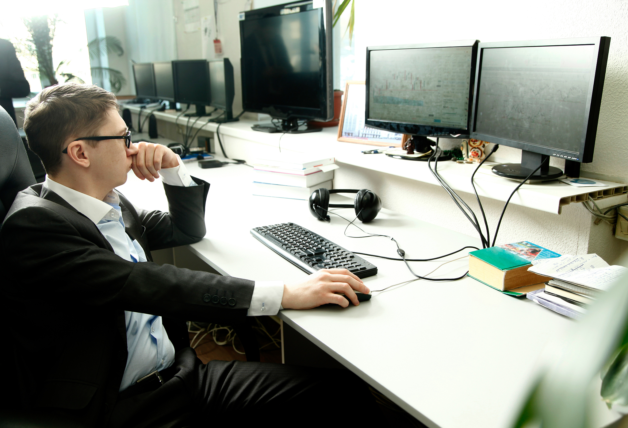 man workin<strong>g</strong> at a computer in the office with monitors