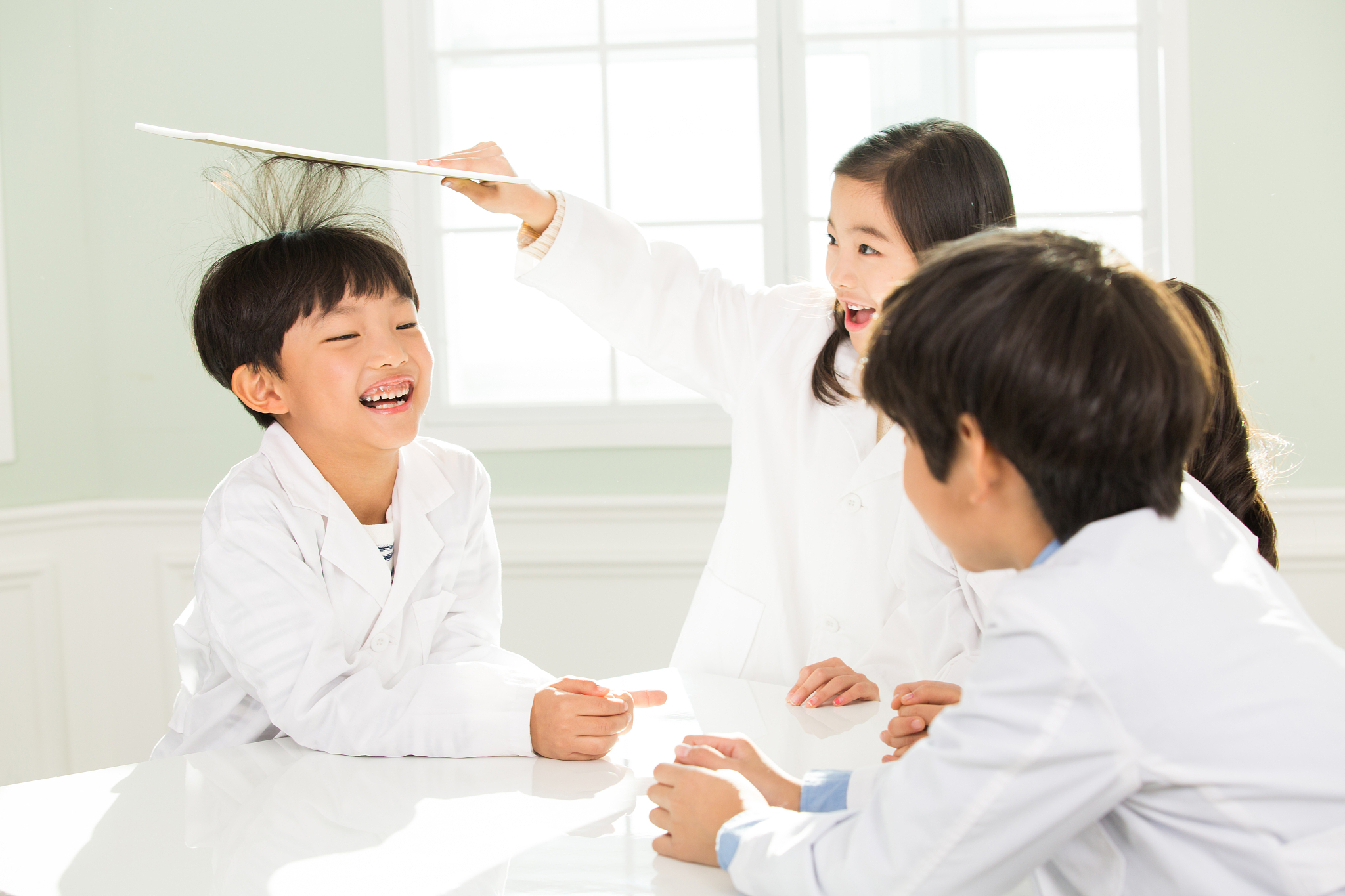 young students in lab coats playing
