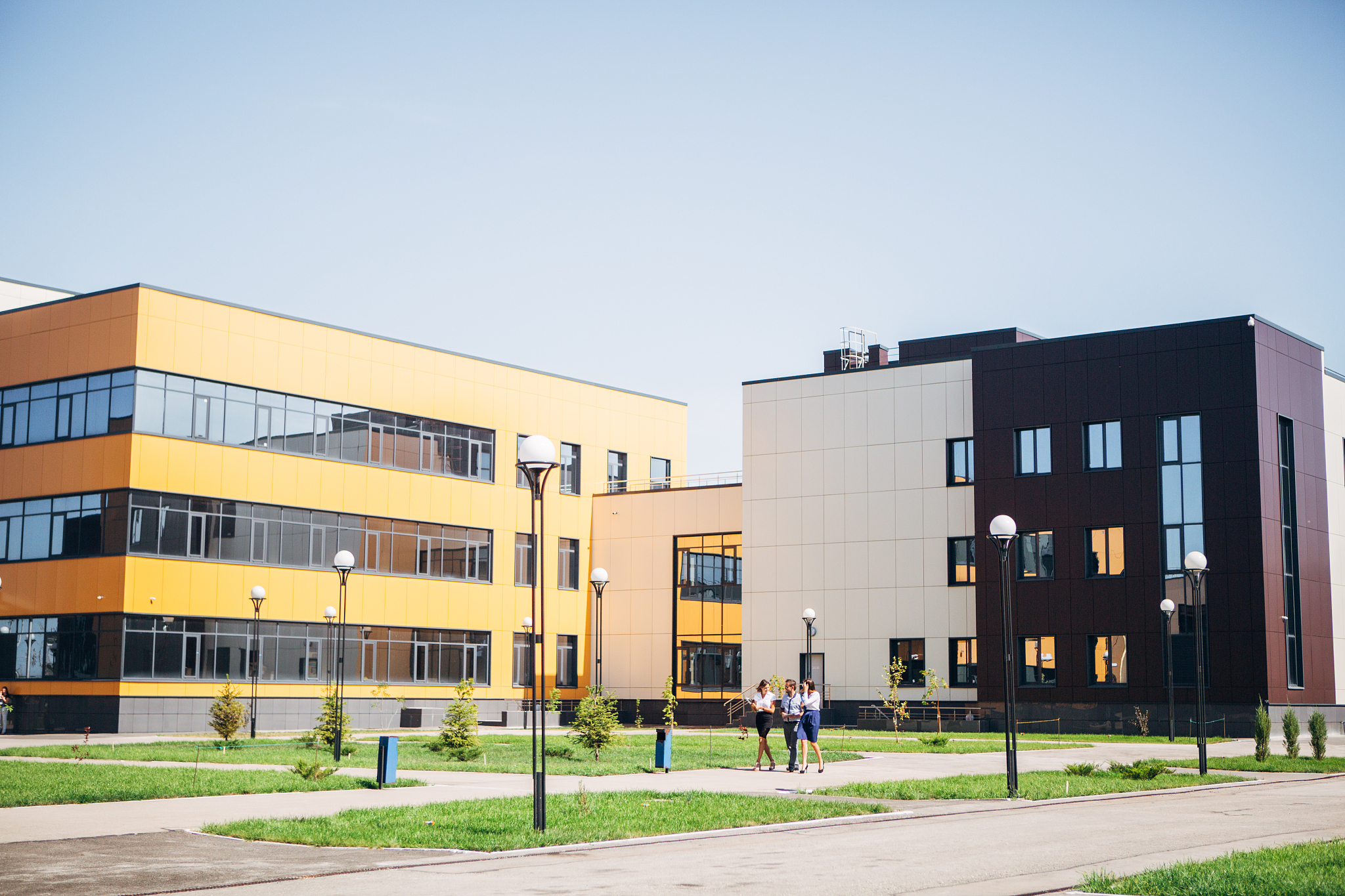 three colleagues walk through the innovation center and communic