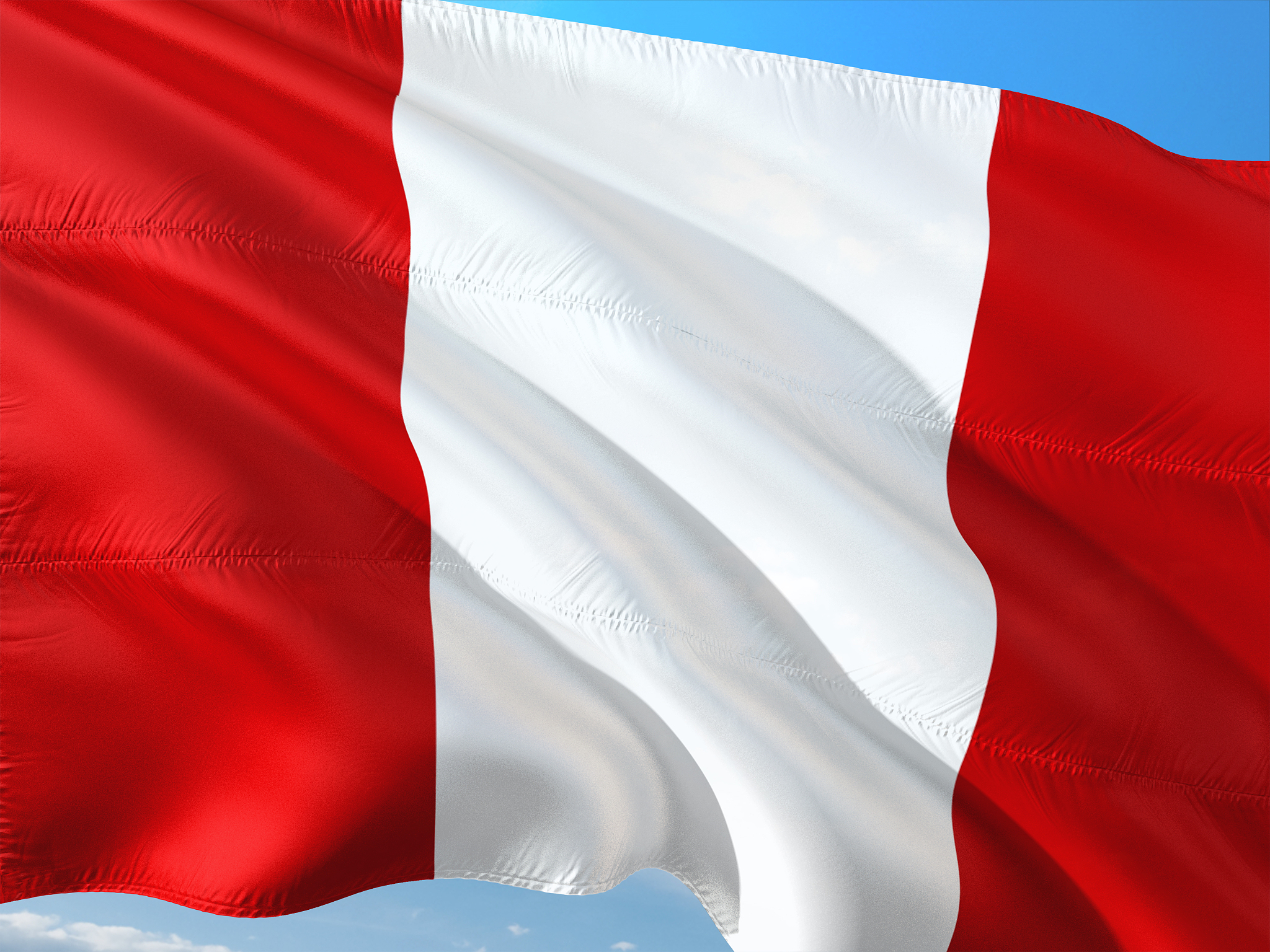 flag of peru waving in the wind against deep blue sky. high qual