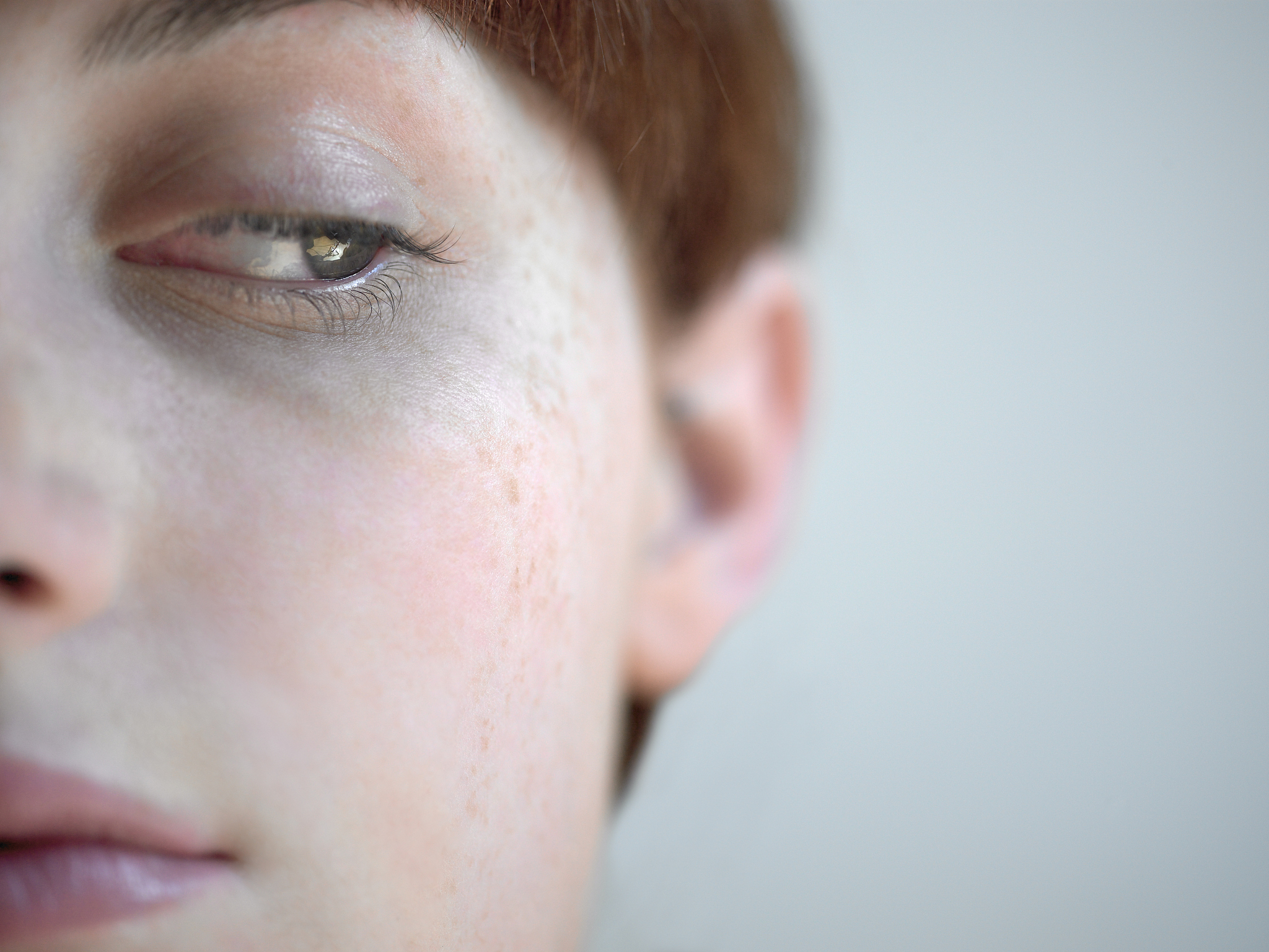 young woman looking down, close-up of face