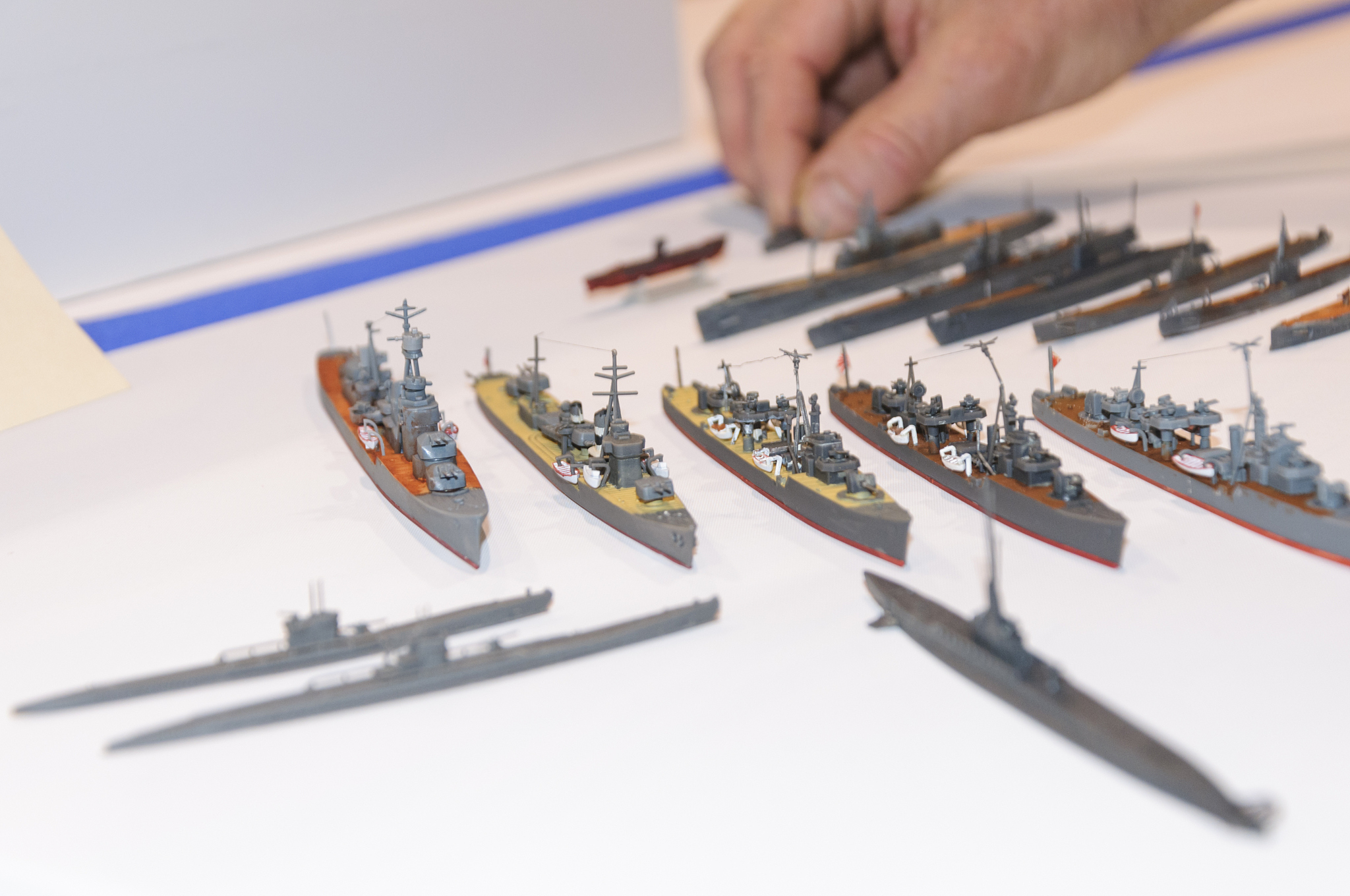 a craftsman displays his model ships