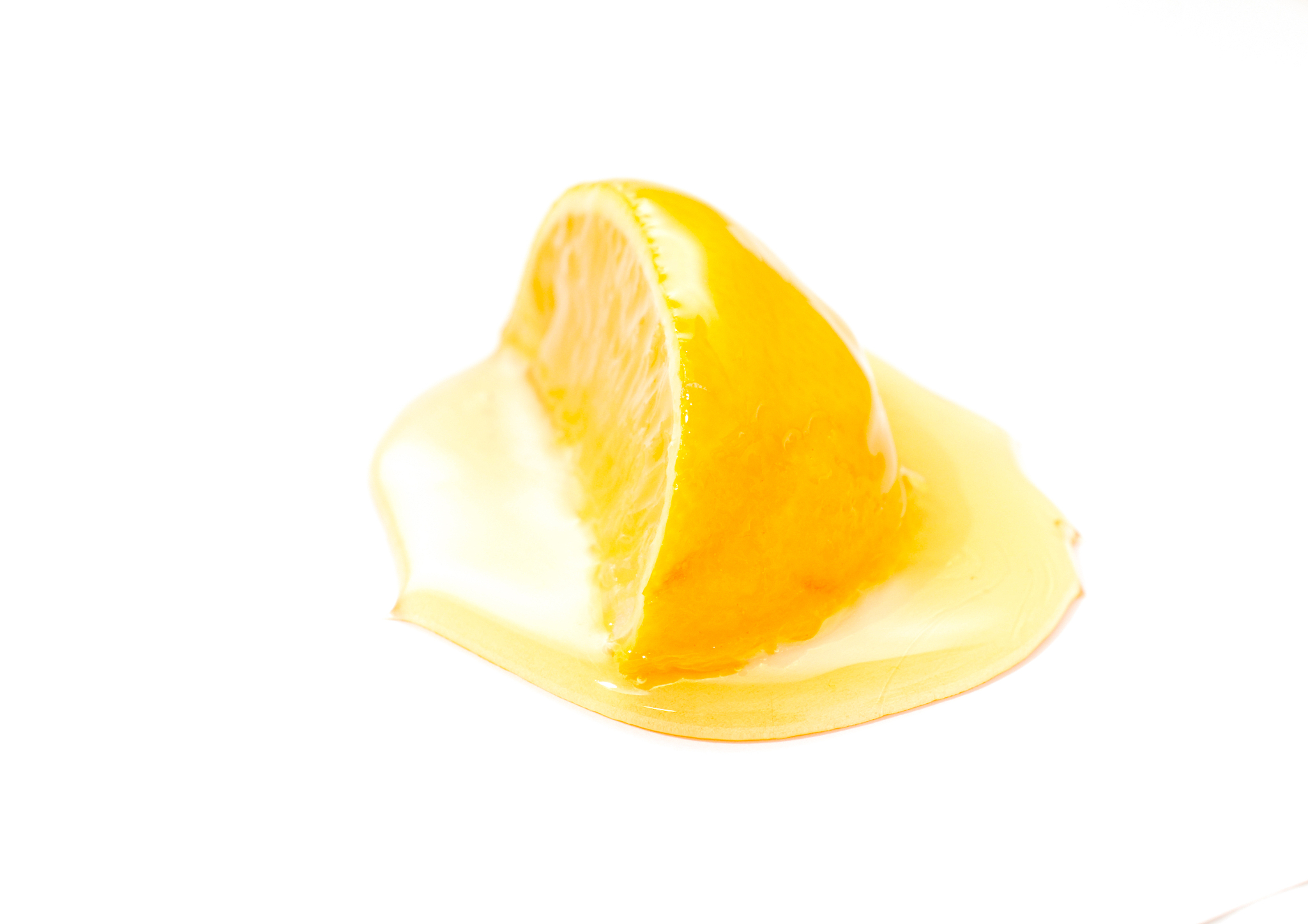 slice of lemon and honey , shallow dof, white background