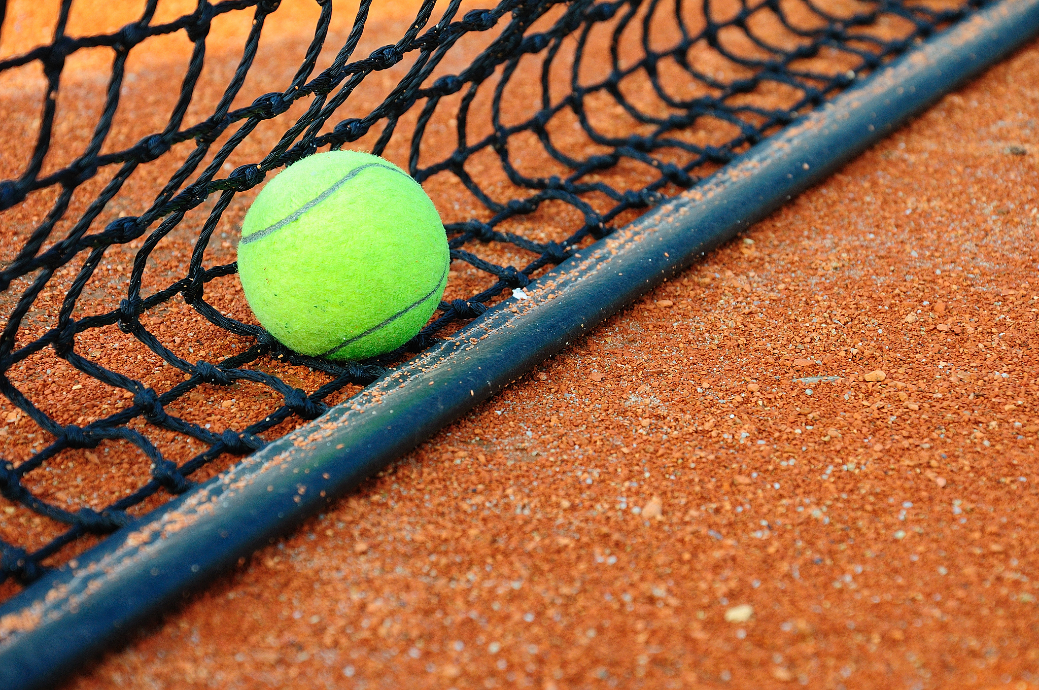 tennisball on a tennis clay court