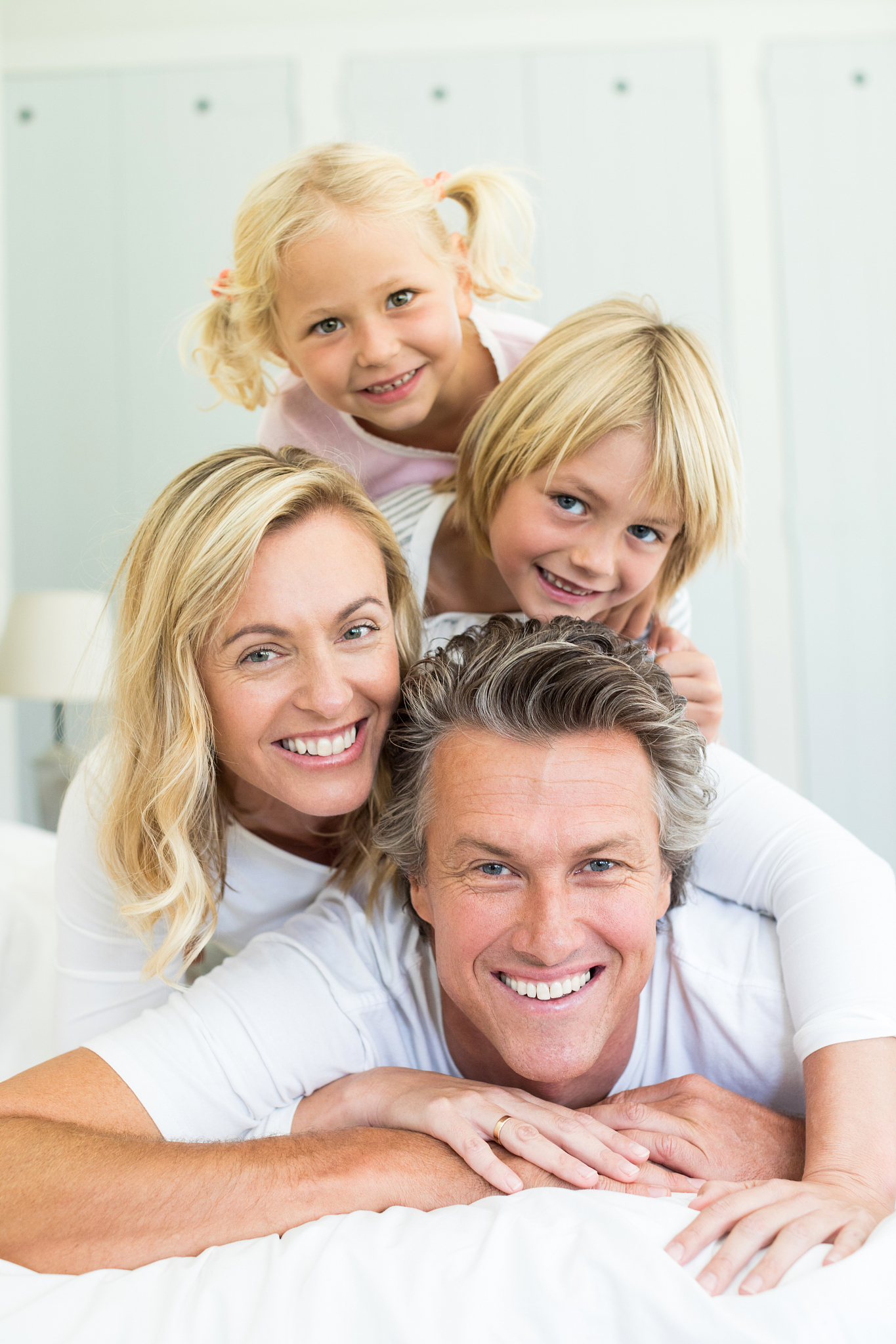 happy family having fun on bed in the bed room