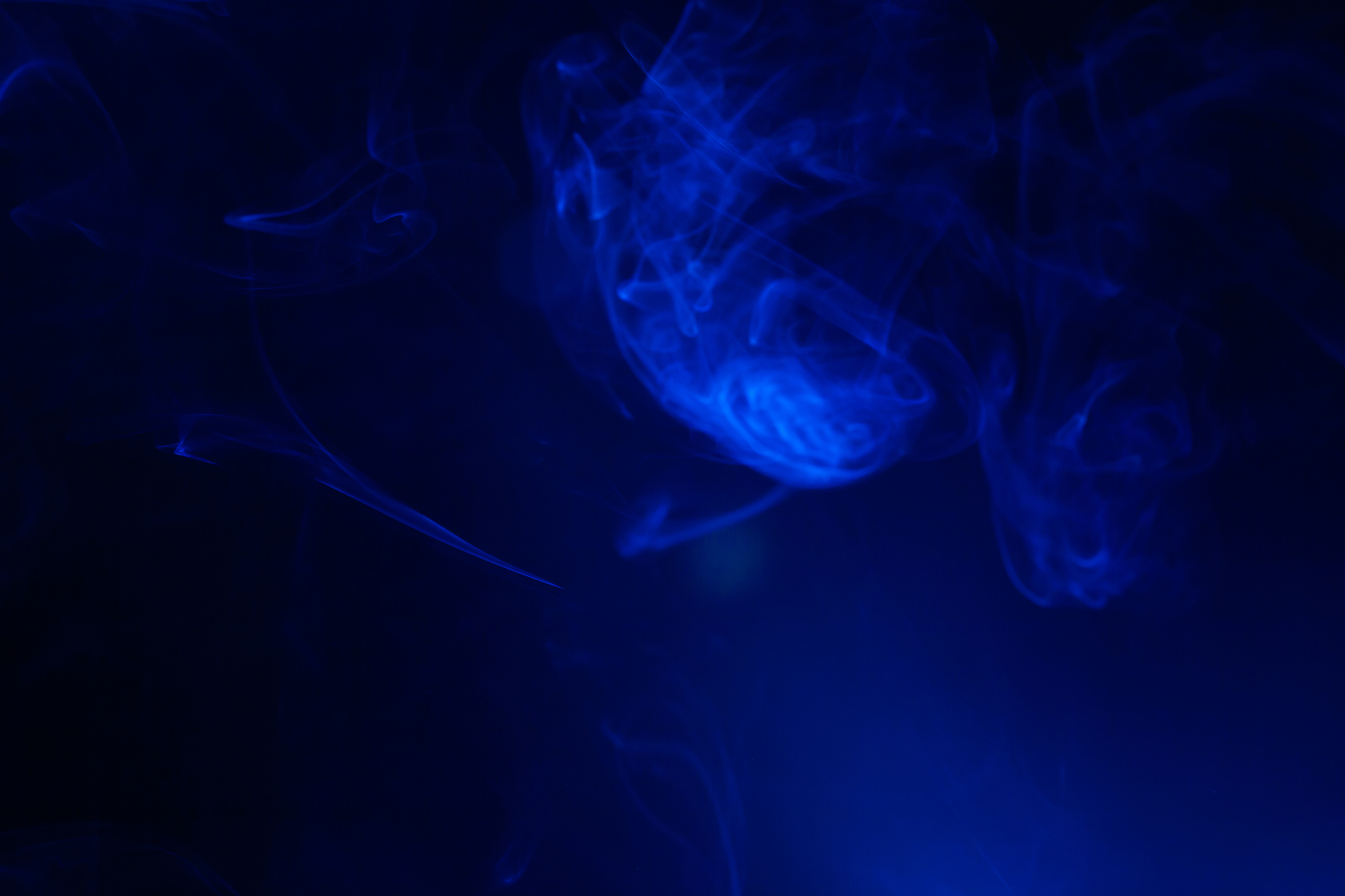 blue smoke on black background.