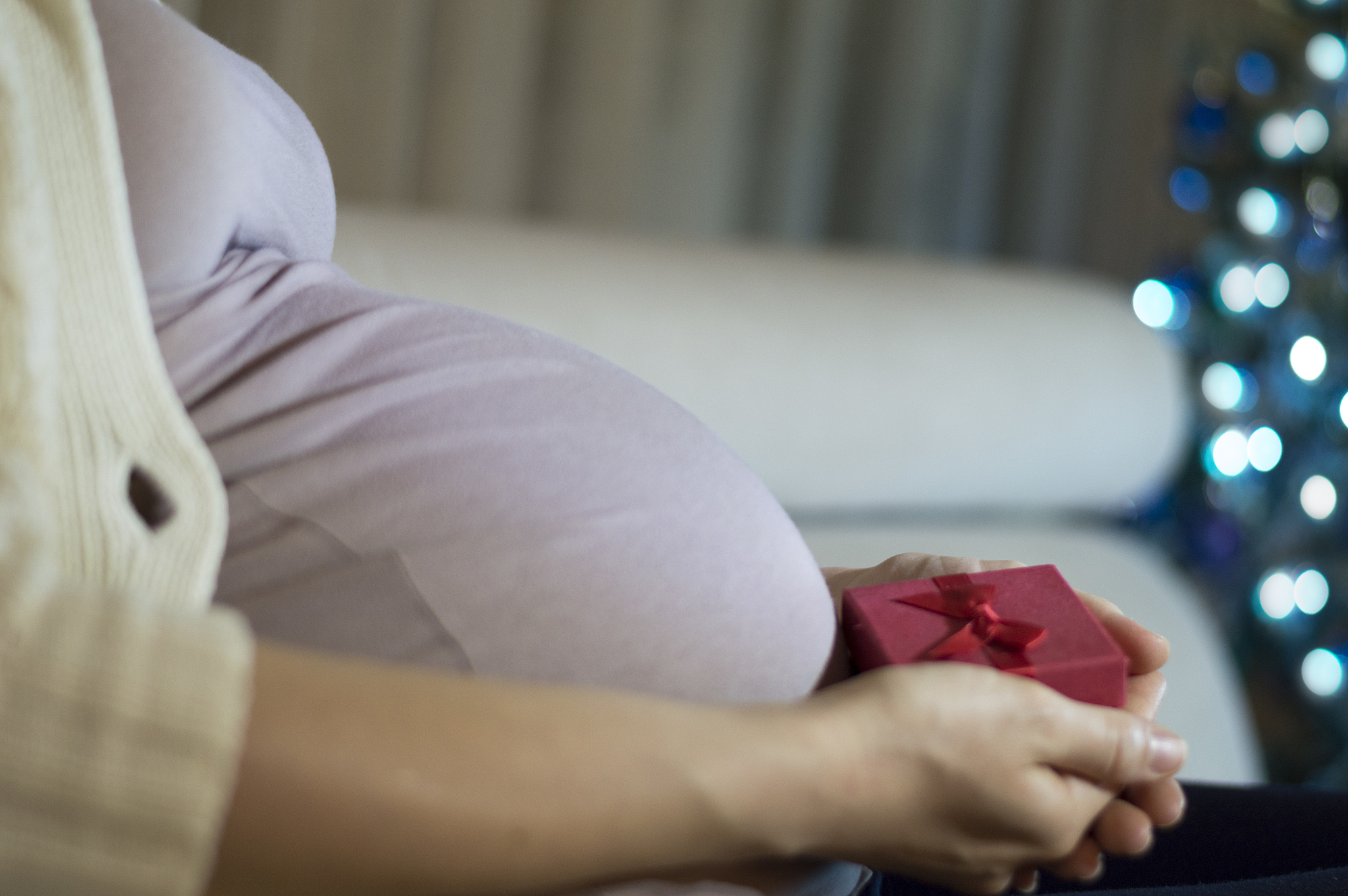 pregnant belly with a present. it's christmas
