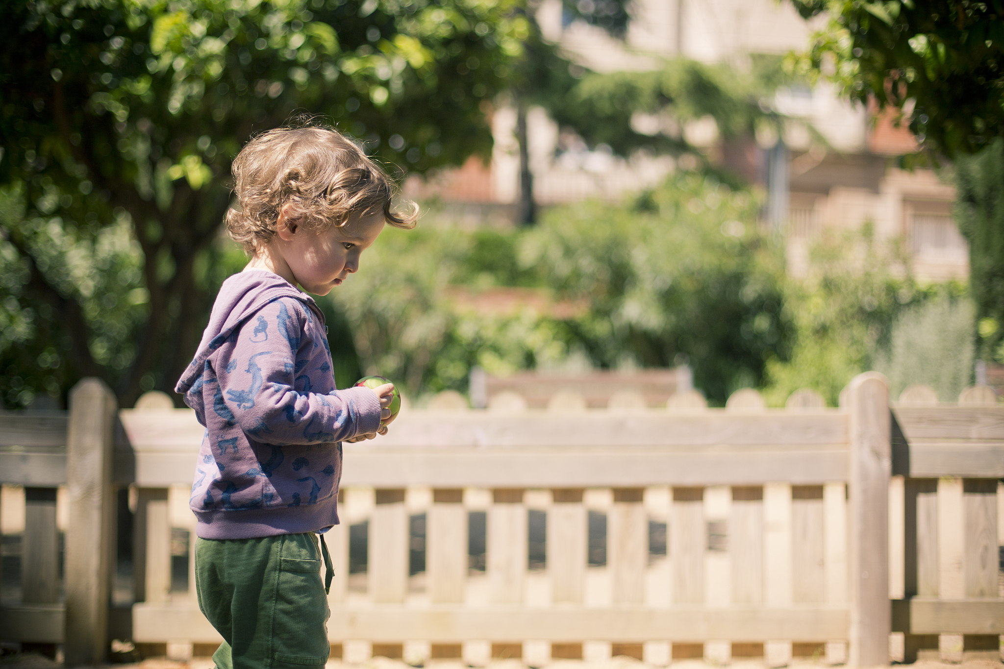 boy with ball looking down