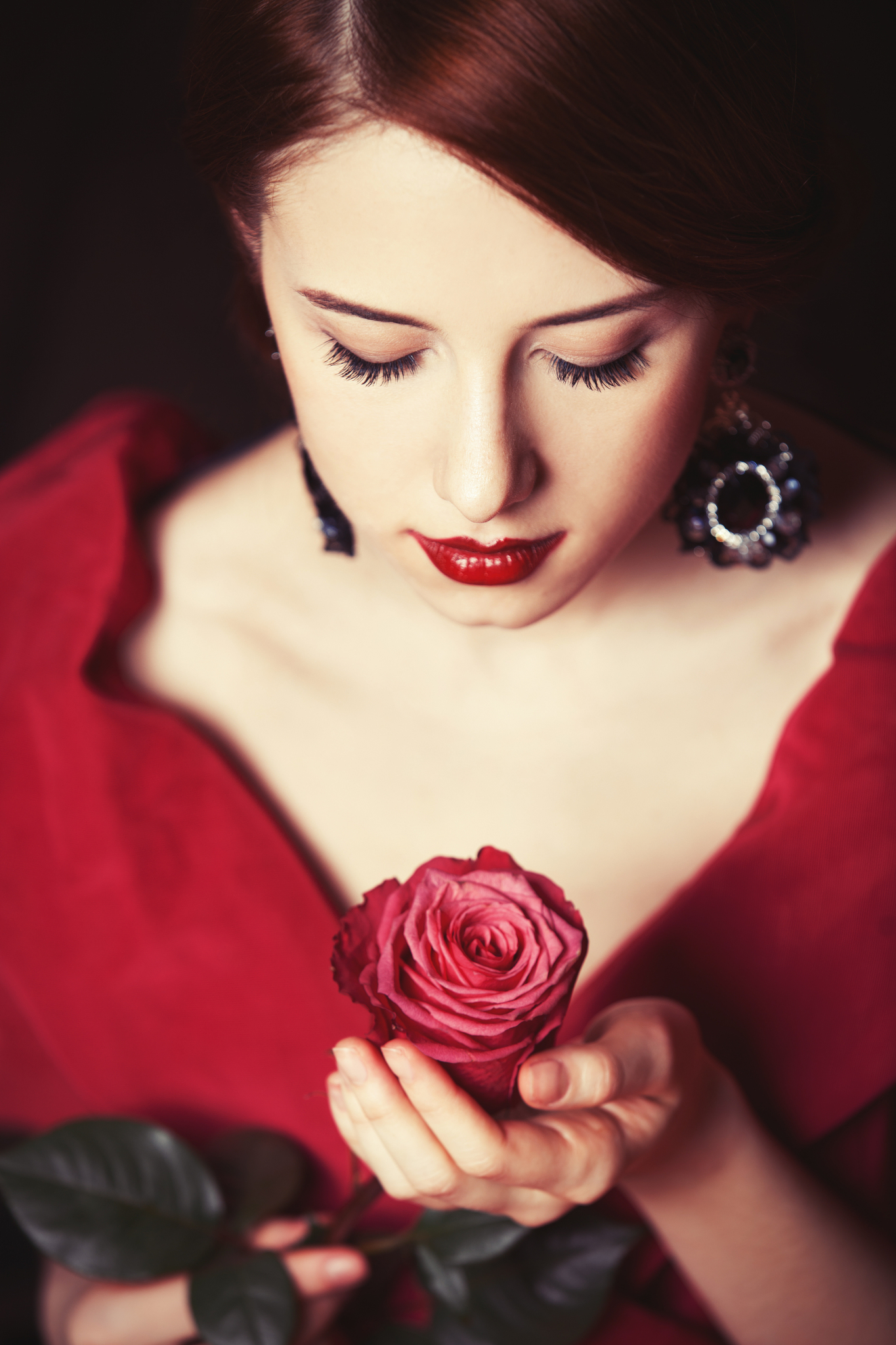 beautiful redhead women with rose.