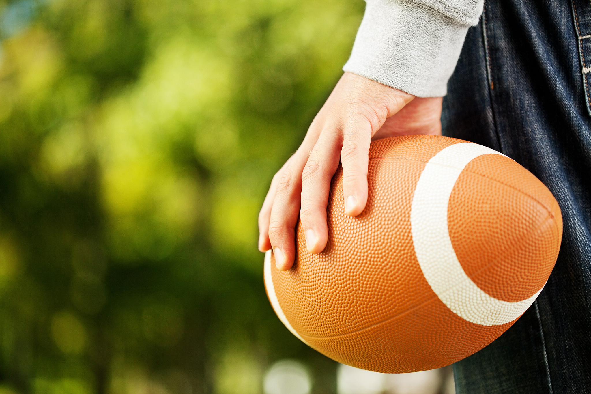 hand holding an american football