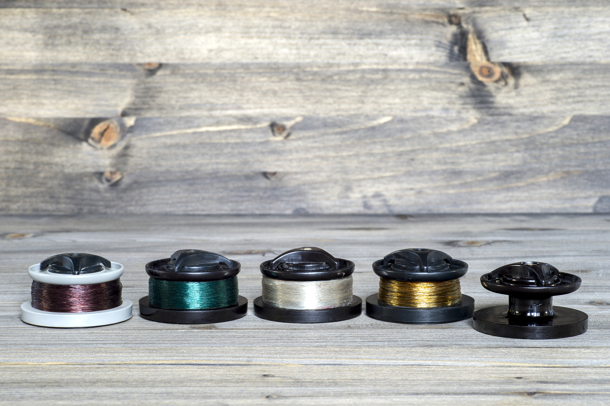set with multi-colored spools with fishing line for fishing on w