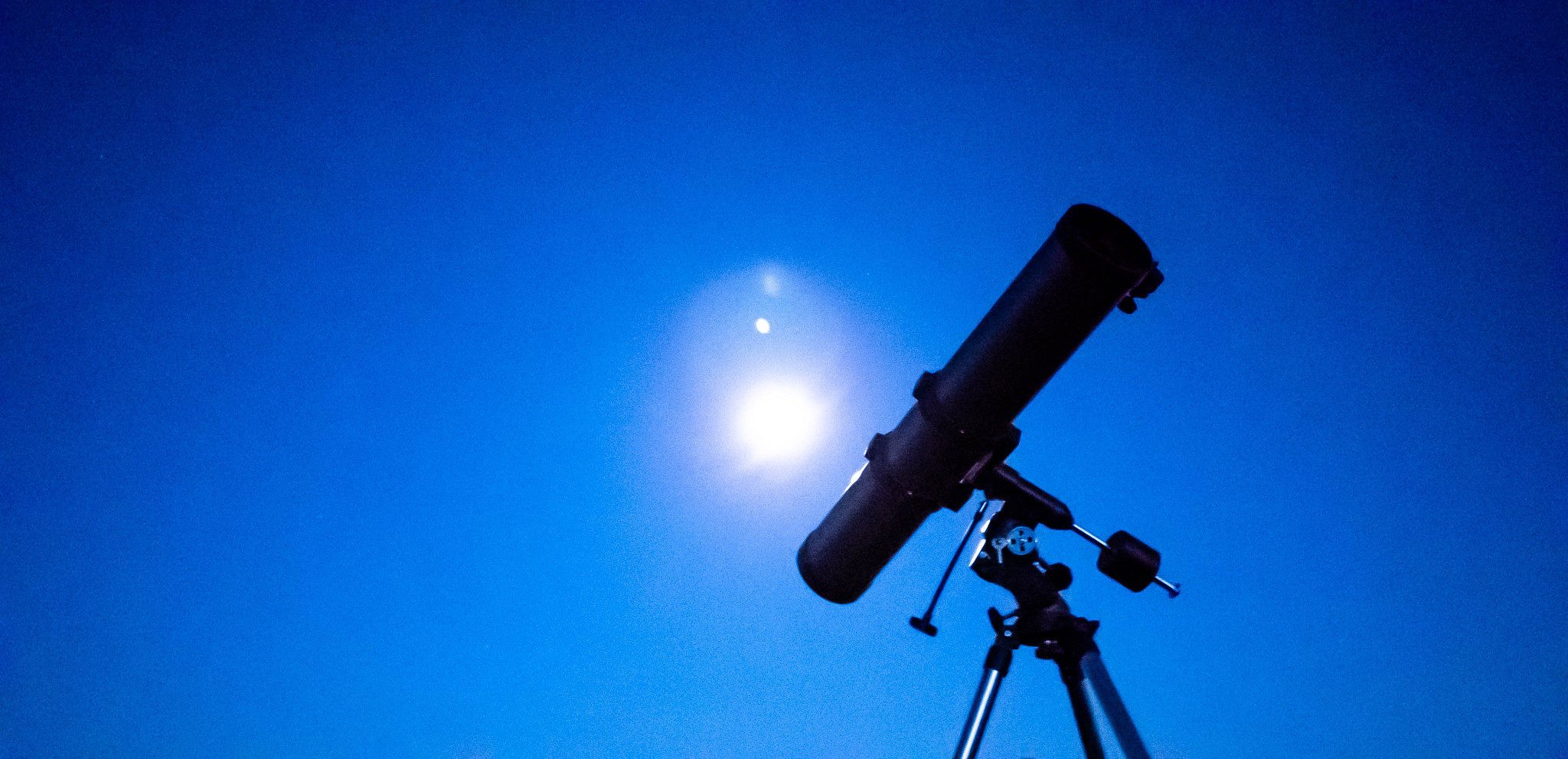 telescope on a tripod at night in nature against the backdrop of