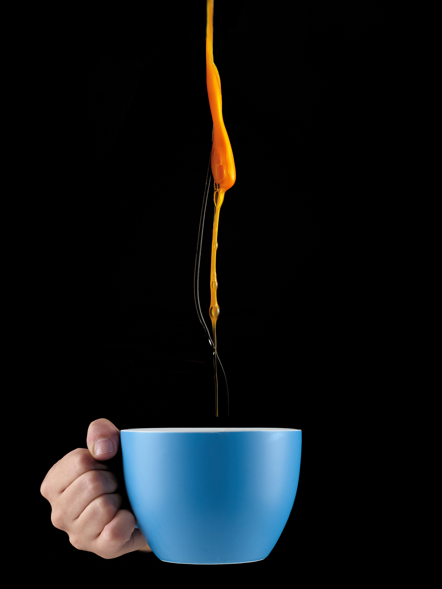 egg yolk dripping in to cup.