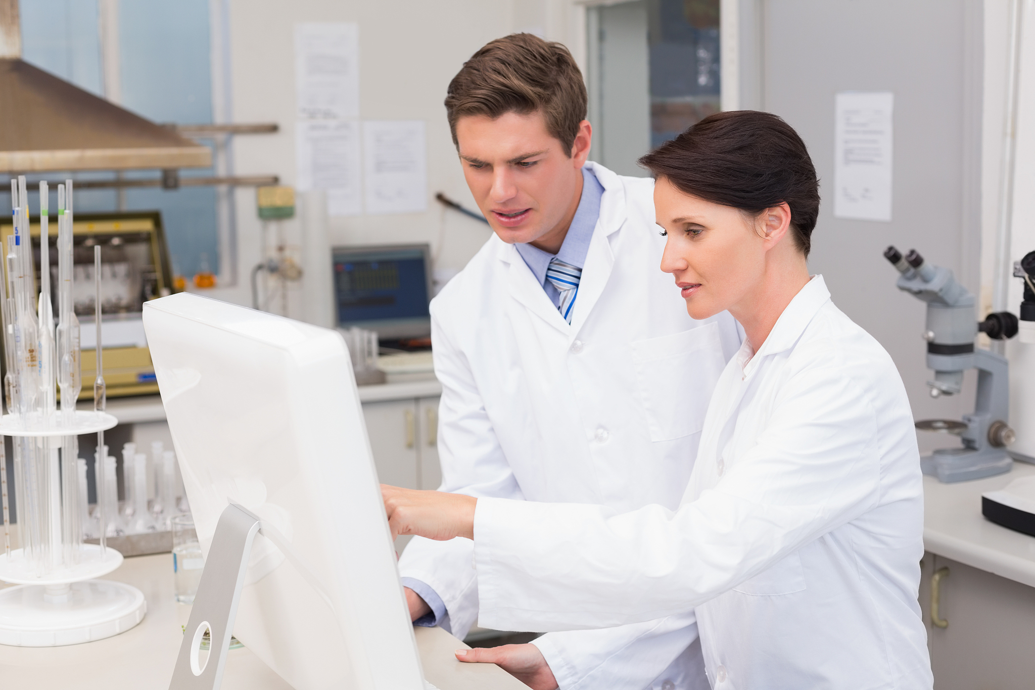scientists looking attentively at computer