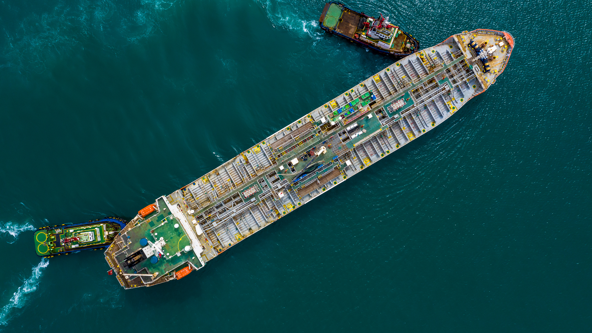 aerial top view of fuel tanker ship at the port, oil terminal is