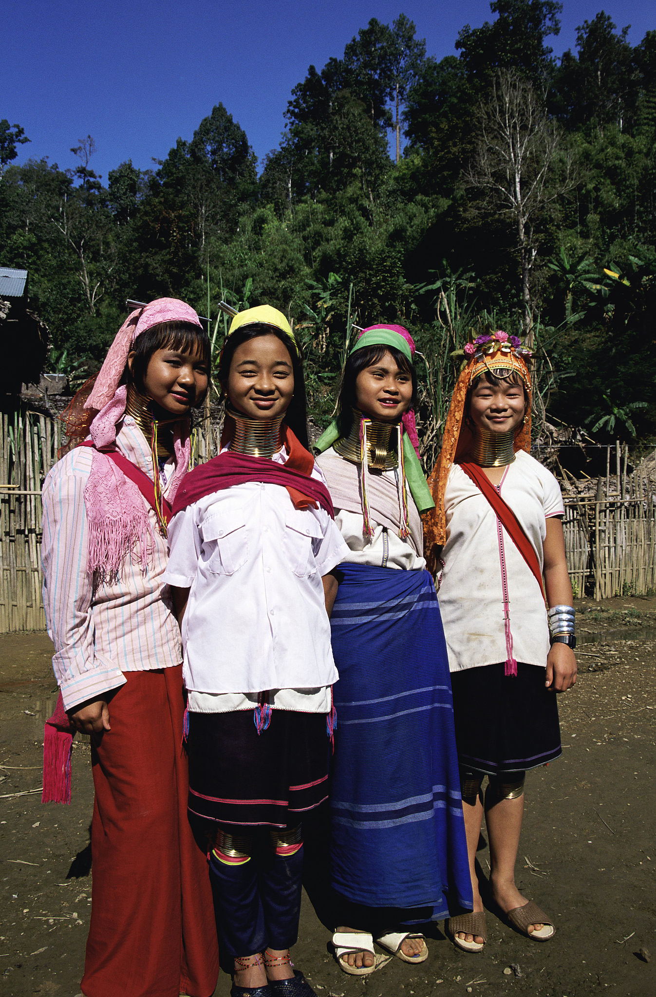 four padaung women in traditional clothing, mae hong son, thaila