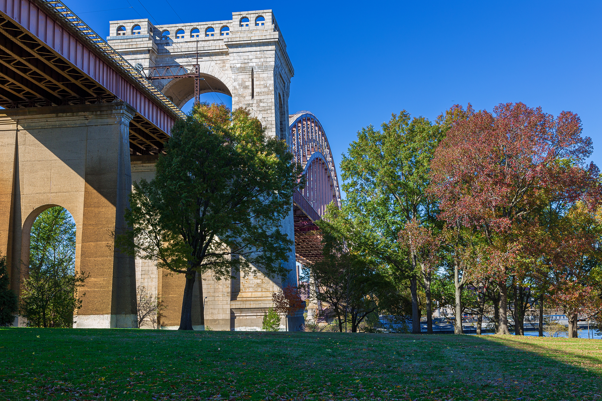 hell gate bridge and trees in autumn colors as seen from astoria