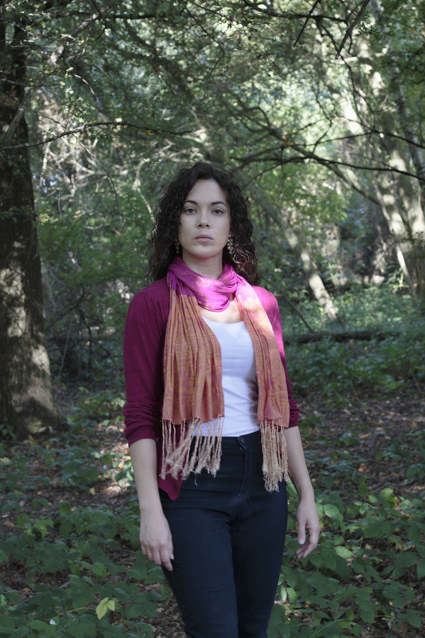 curly-haired beautiful canadian outdoor girl in shady woodland