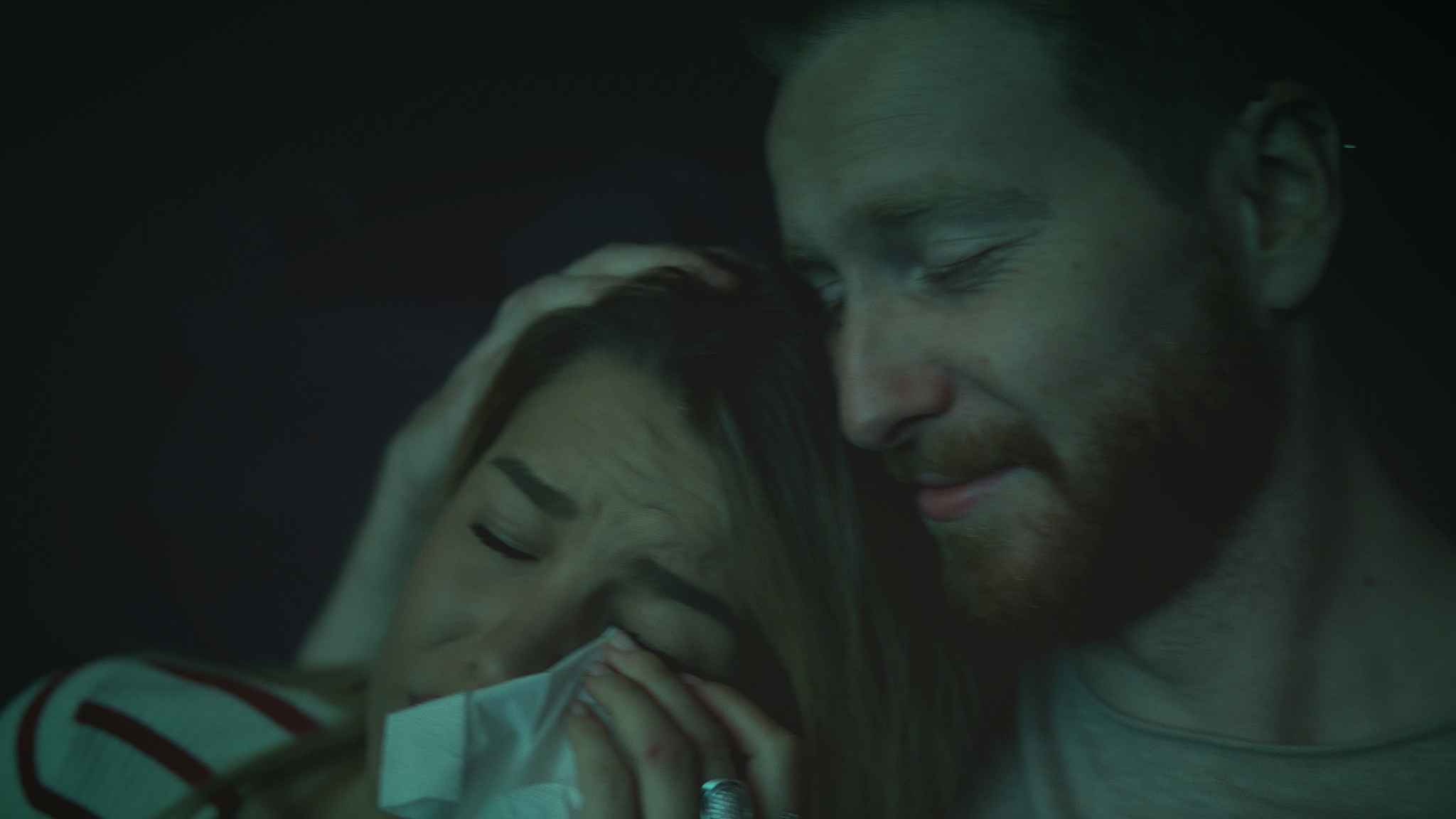 women crying while watching movie in a cinema hall